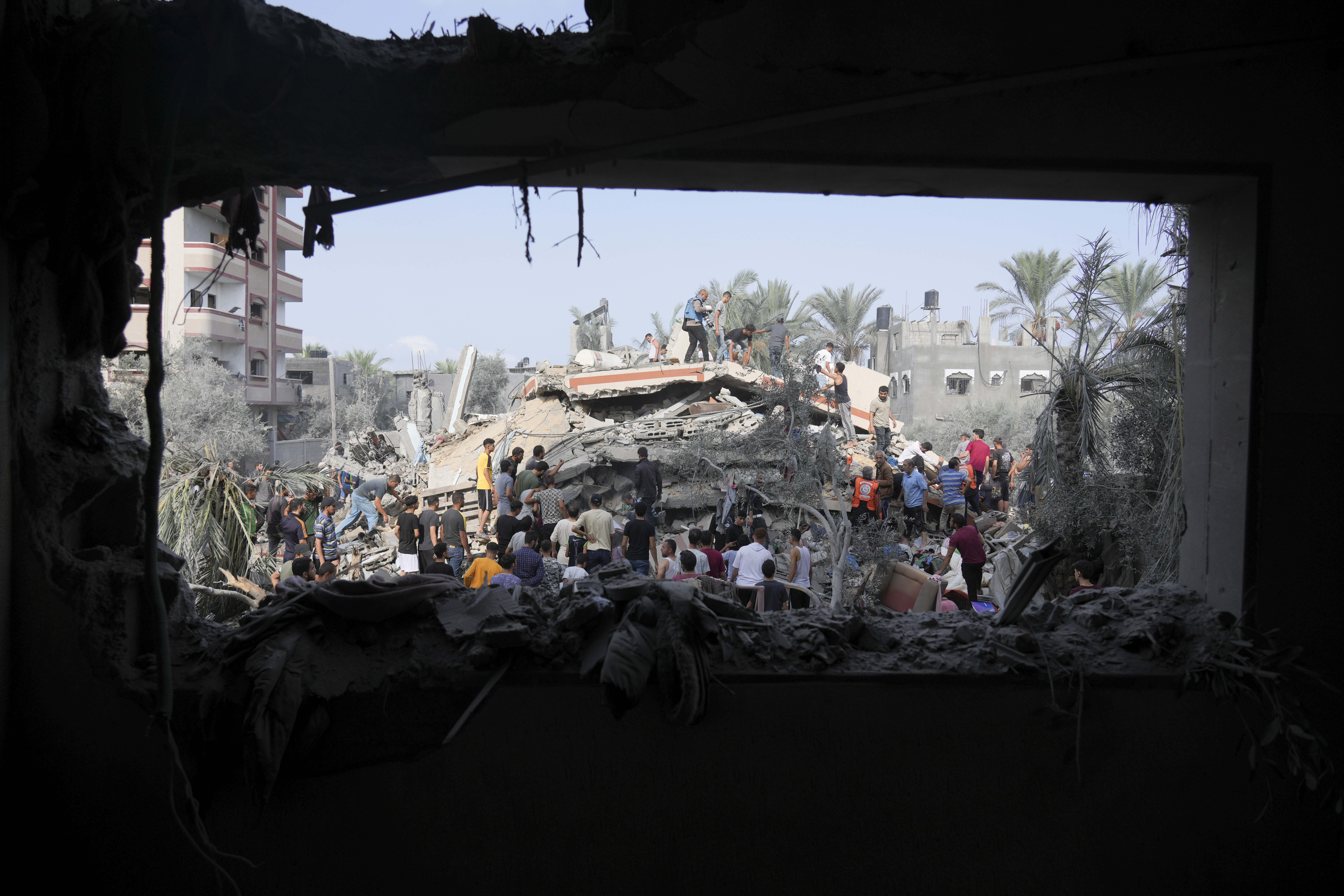 This photo from last month shows Palestinians looking for survivors after the Israeli bombardment of the Gaza Strip in Deir Al-Balah. Photo / AP