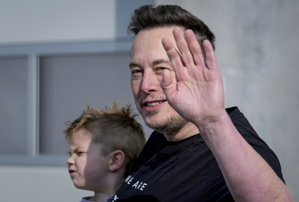 Tesla CEO Elon Musk waves as he leaves the Tesla Gigafactory for electric cars after a visit in Gruenheide near Berlin, Germany on March 13. Photo / AP