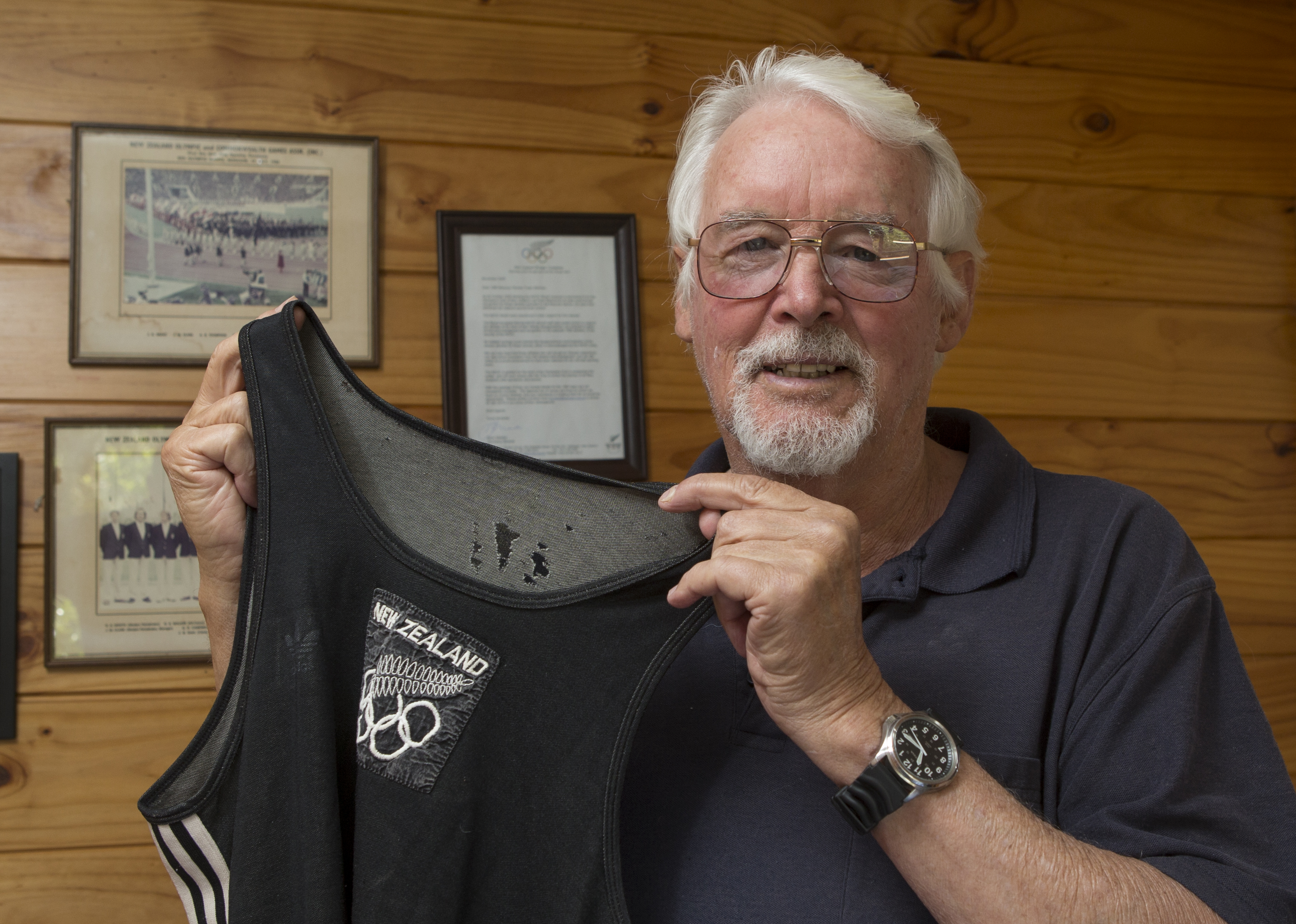 Brian Newth at home with his competition singlet.  Photo / Mark Mitchell 