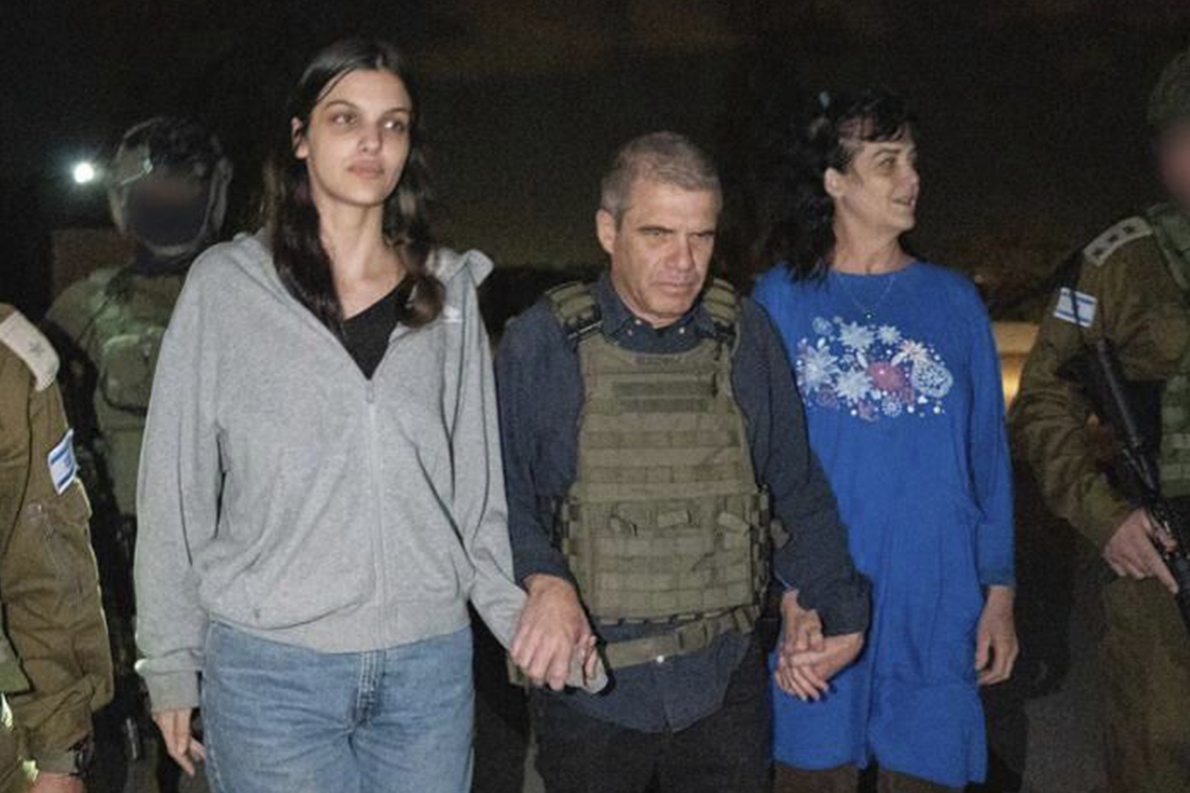 Judith Raanan (right) and her 17-year-old daughter Natalie are escorted by Israeli soldiers and Gal Hirsch, Prime Minister Benjamin Netanyahu's special co-ordinator for returning the hostages, as they return to Israel from captivity in the Gaza Strip on October 20. Photo / AP