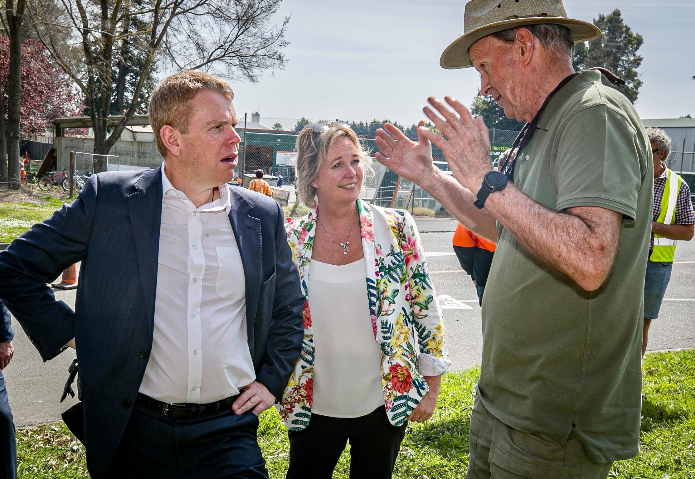 Chris Hipkins reacts as Cyclone Gabrielle affected resident Mike Glazebrook (right) of Biorich recounts his experience during the storm at a visit to the Henderson Road Transfer Station in Hastings. Photo / Warren Buckland