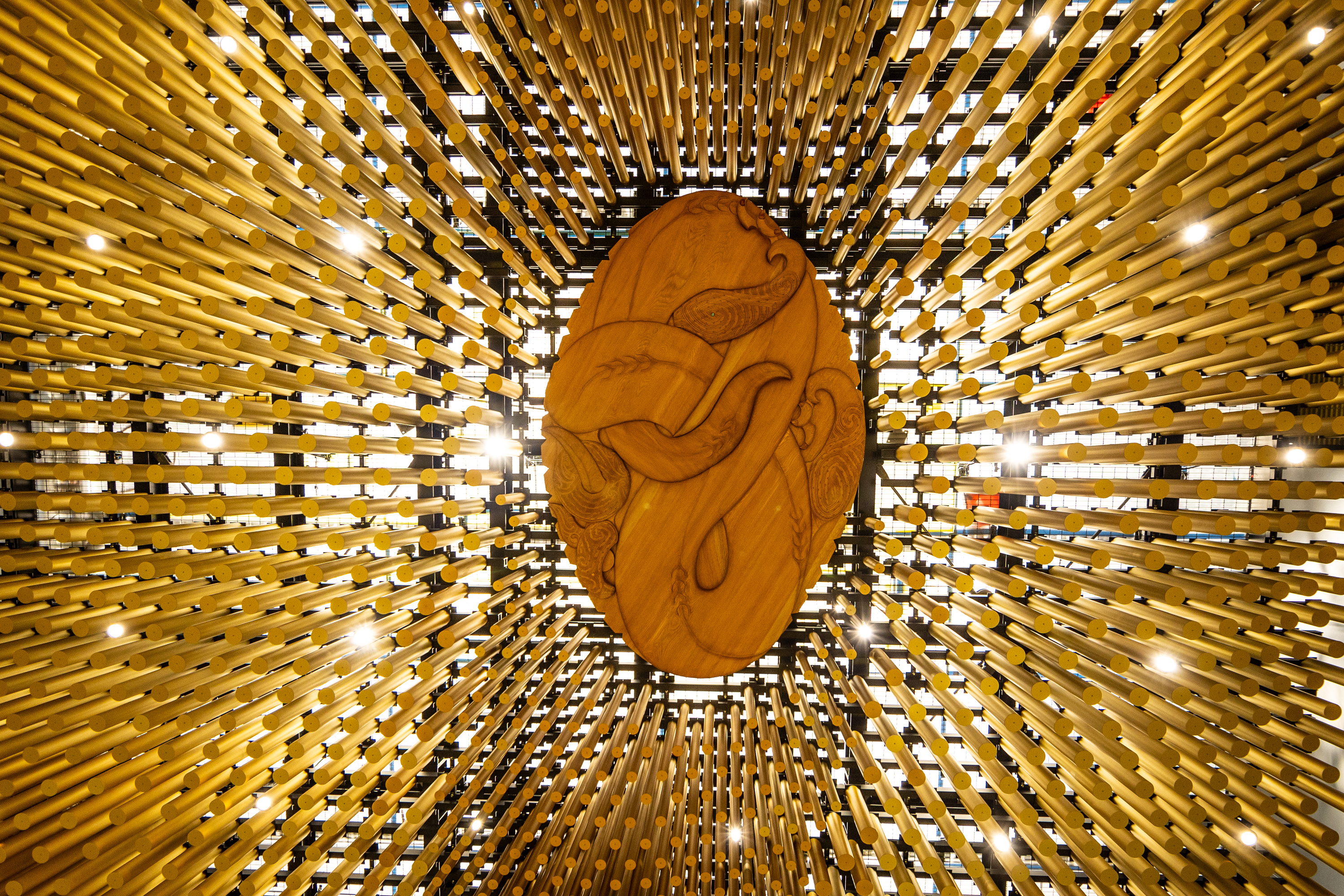 Four thousand bronze rods represent reeds of the stream and the kaitiaki is represented by a kauri carving at their centre in the new train station. Photo / Michael Craig

