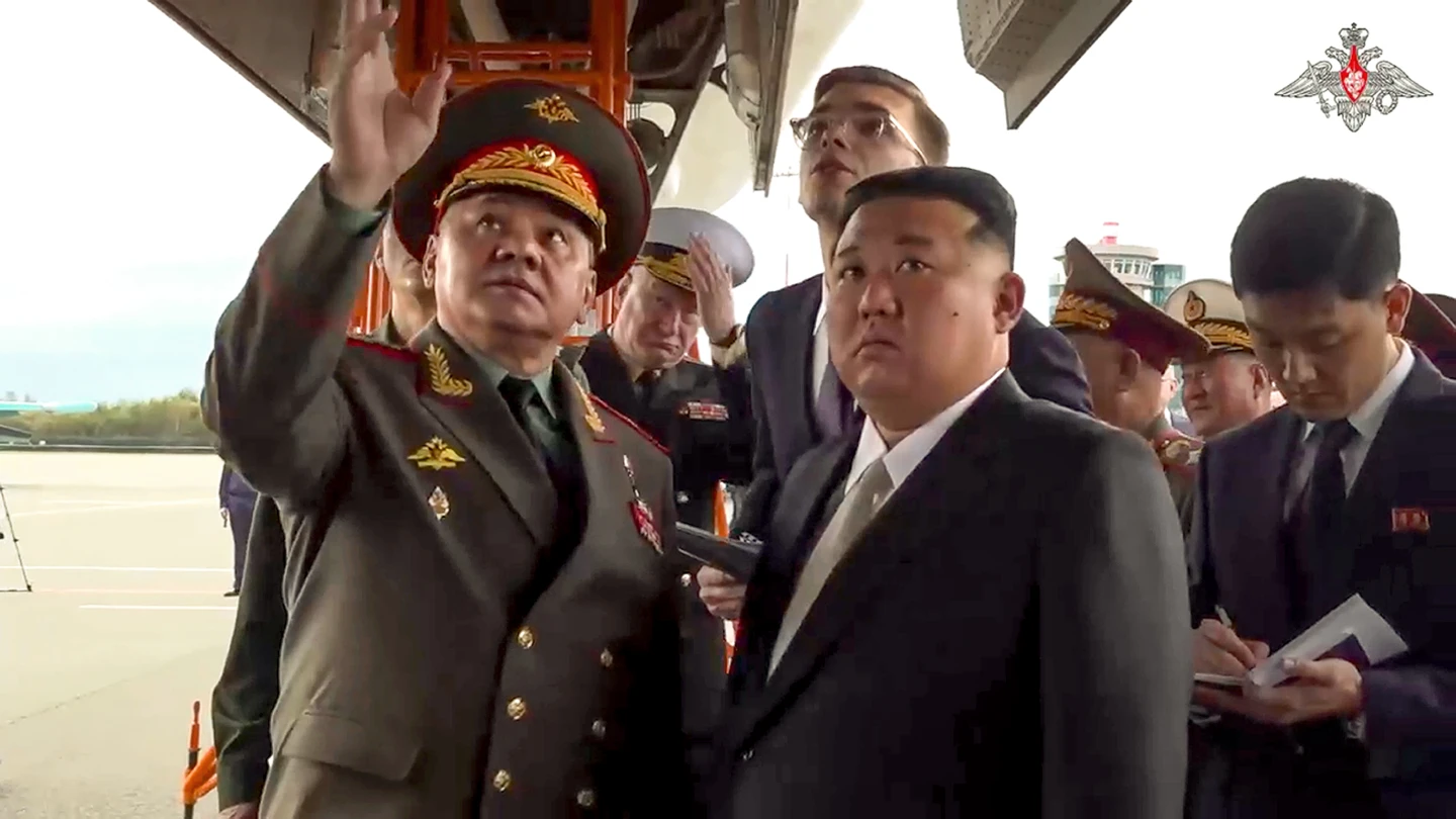 North Korea's leader Kim Jong Un listens to Russian Defence Minister Sergei Shoigu as he inspects Russian warplanes at an airport outside of Vladivostok. Photo / AP