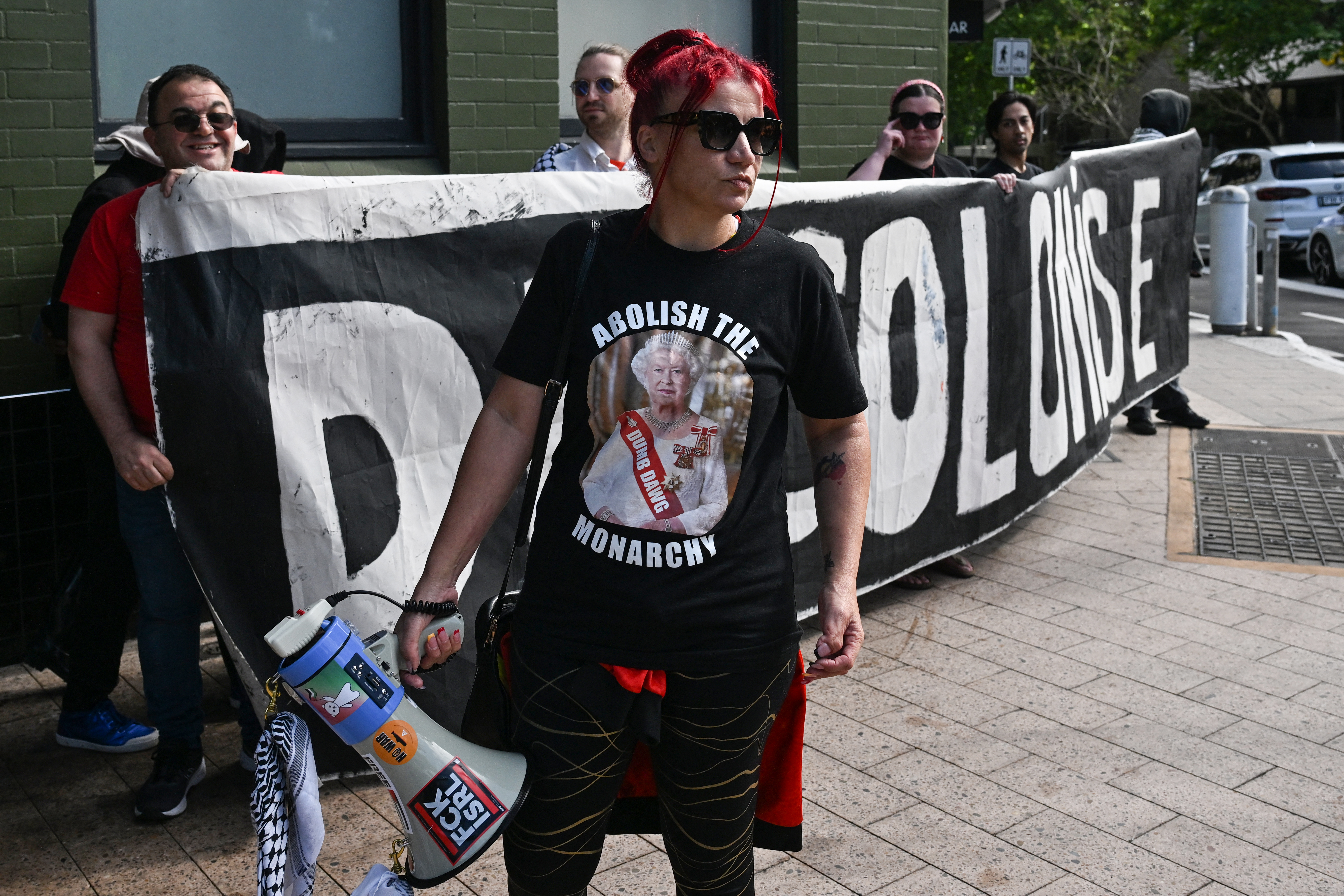 Protesters hold a sign near the St Thomas' Anglican Church, where Britain's King Charles III and Queen Camilla were attending a Sunday morning service, in Sydney. Photo / AFP