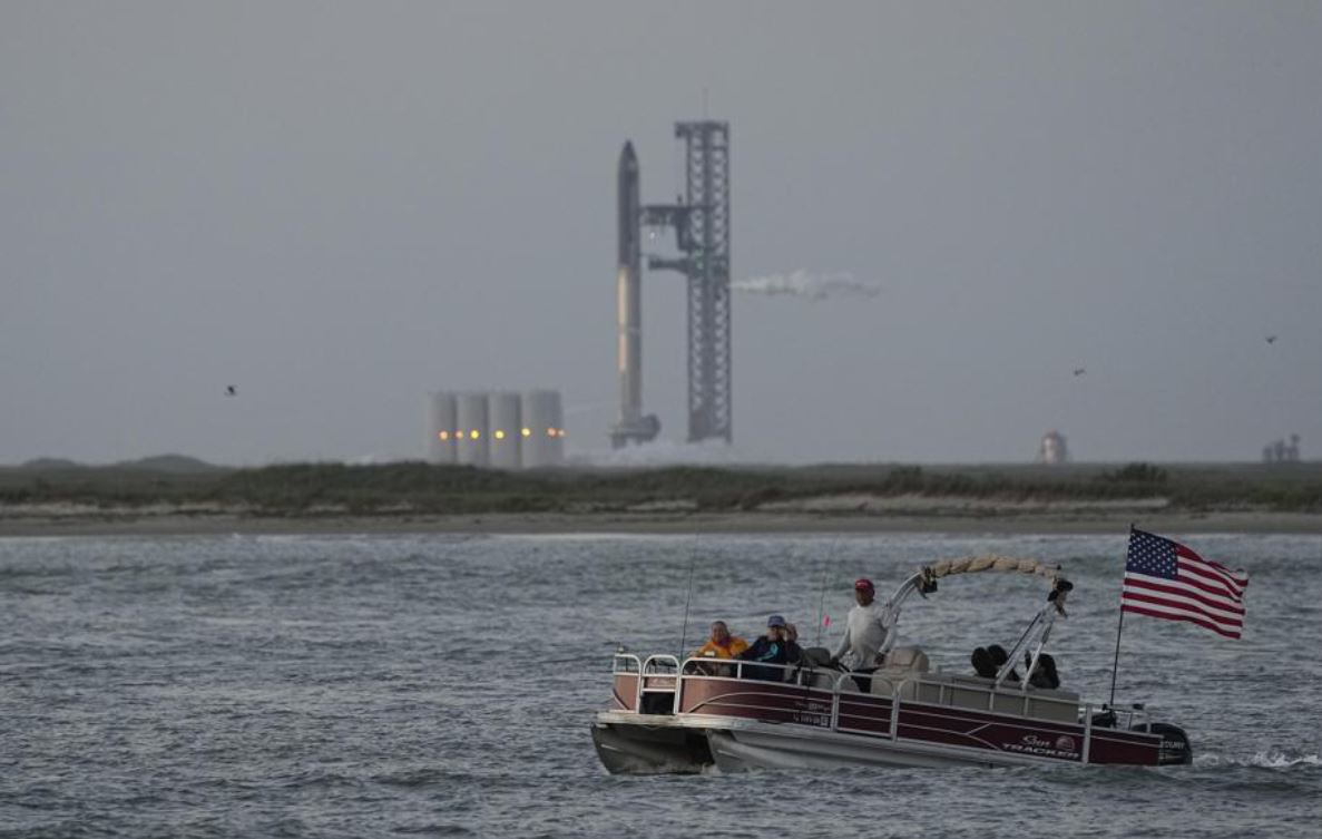 A boat passes SpaceX's Starship, the world's biggest and most powerful rocket, as it prepares to lift off from Starbase in Boca Chica, Texas. Photo / AP