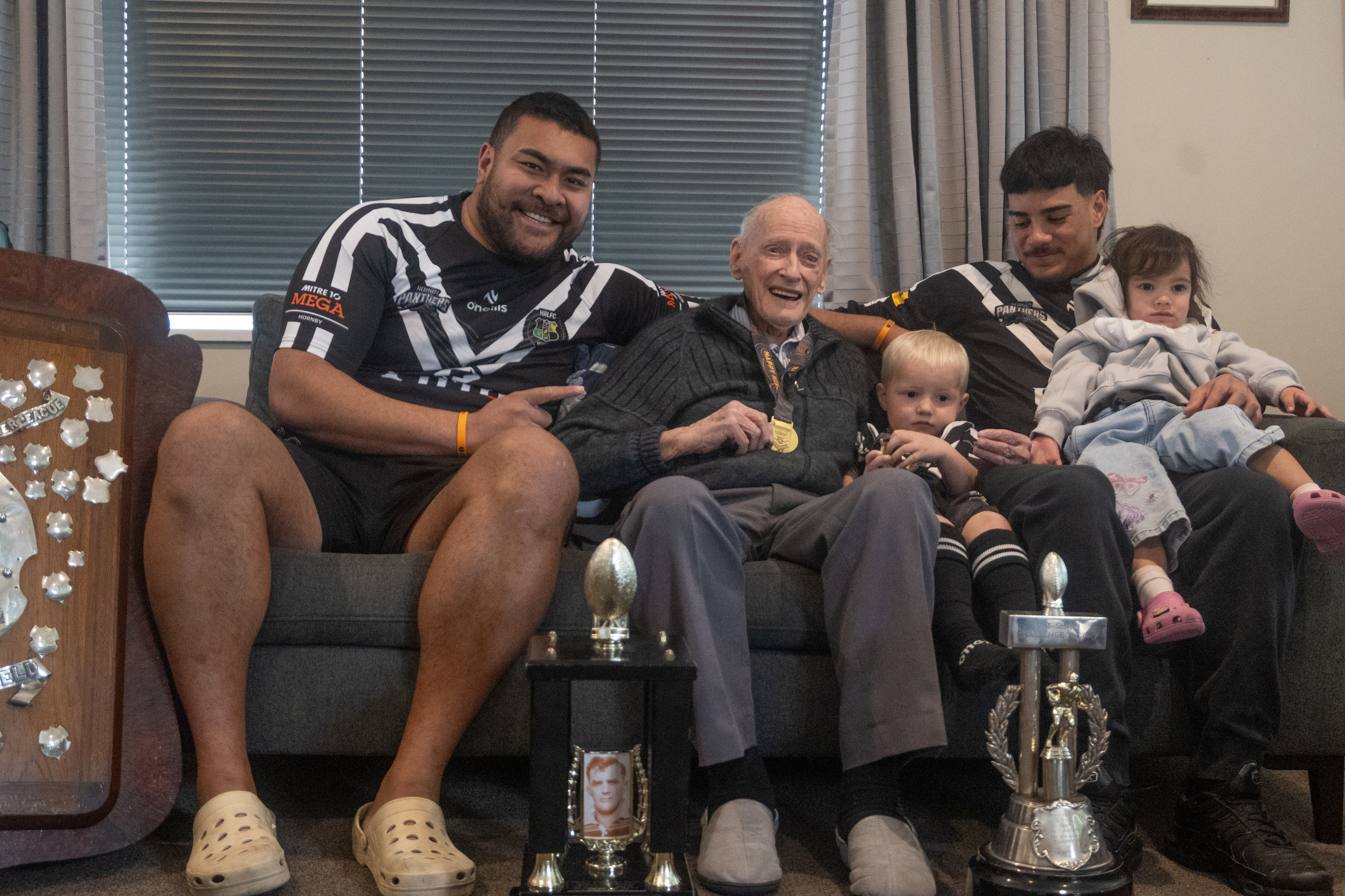 Champ Betham, Dave Cornelius, Kyson (aged 2) and Sincere Harraway (and daughter) with Hornby Panthers' 2024 trophy haul. Photo / Haile Matthews