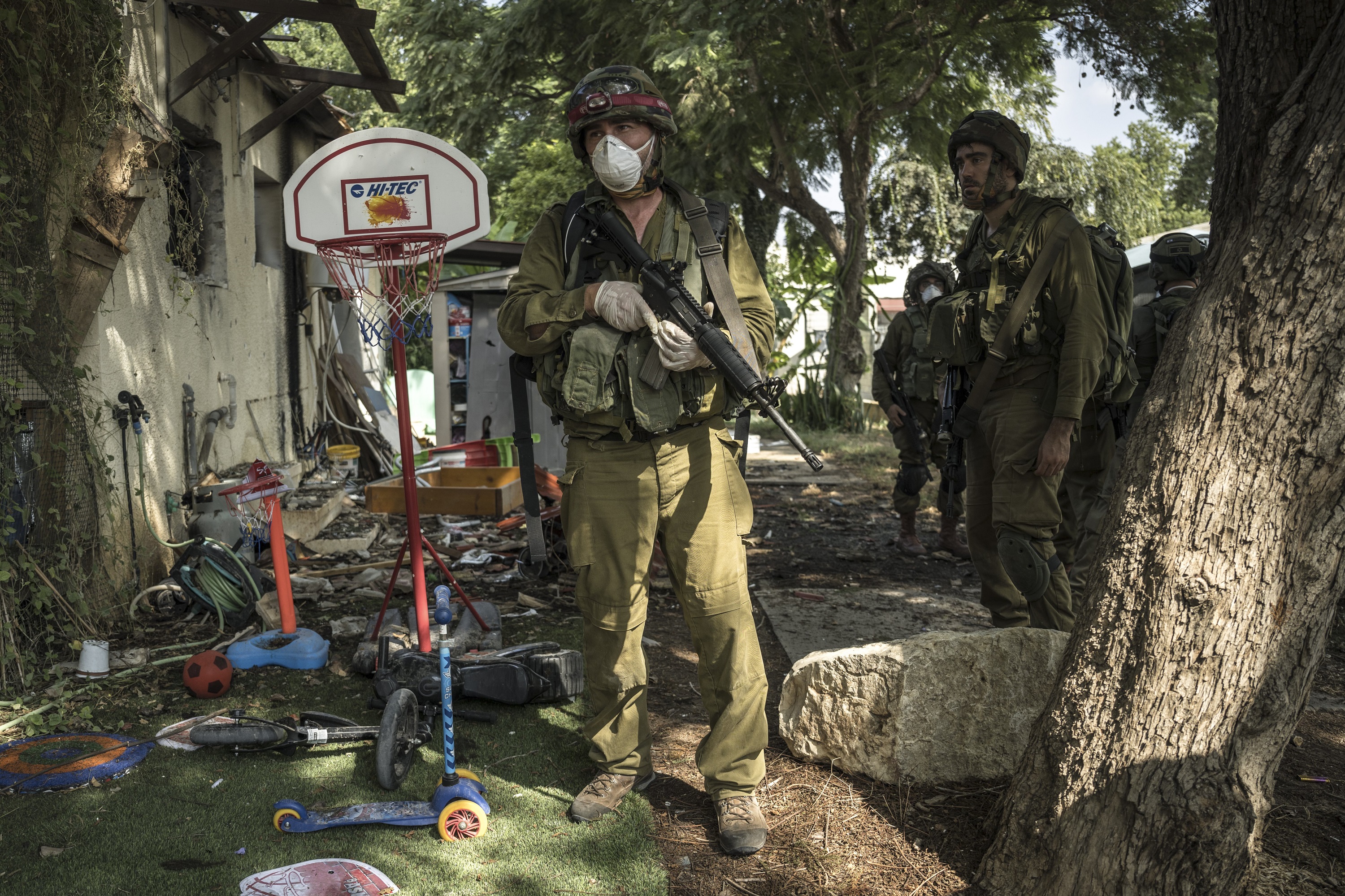 Israeli soldiers near destroyed houses in Kfar Azza. Photo / Sergey Ponomarev, The New York Times