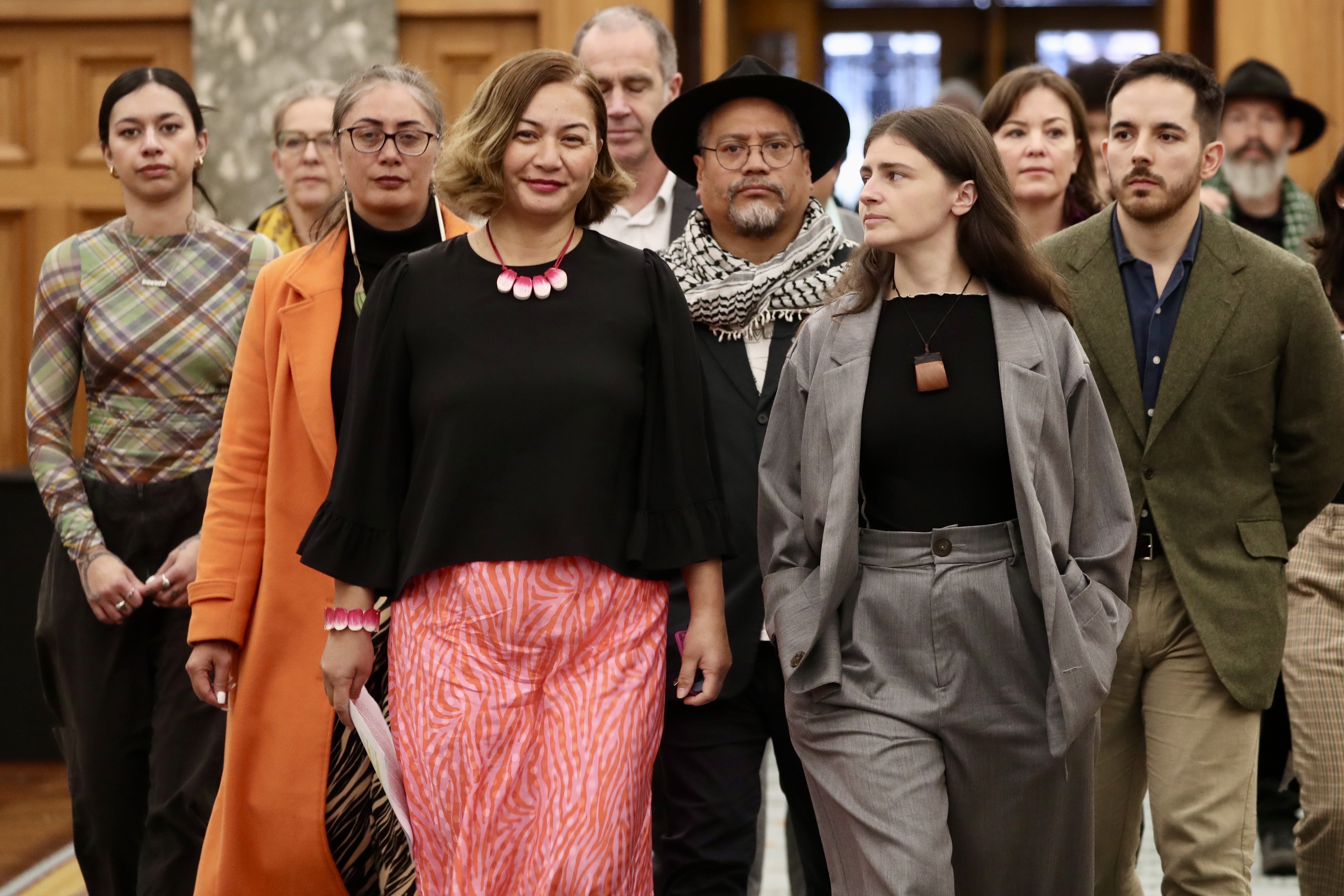 Greens co-leader Marama Davidson, with support from co-leader Chlöe Swarbrick and caucus members, announced her breast cancer diagnosis at Parliament on June 17. Photo / Mark Mitchell