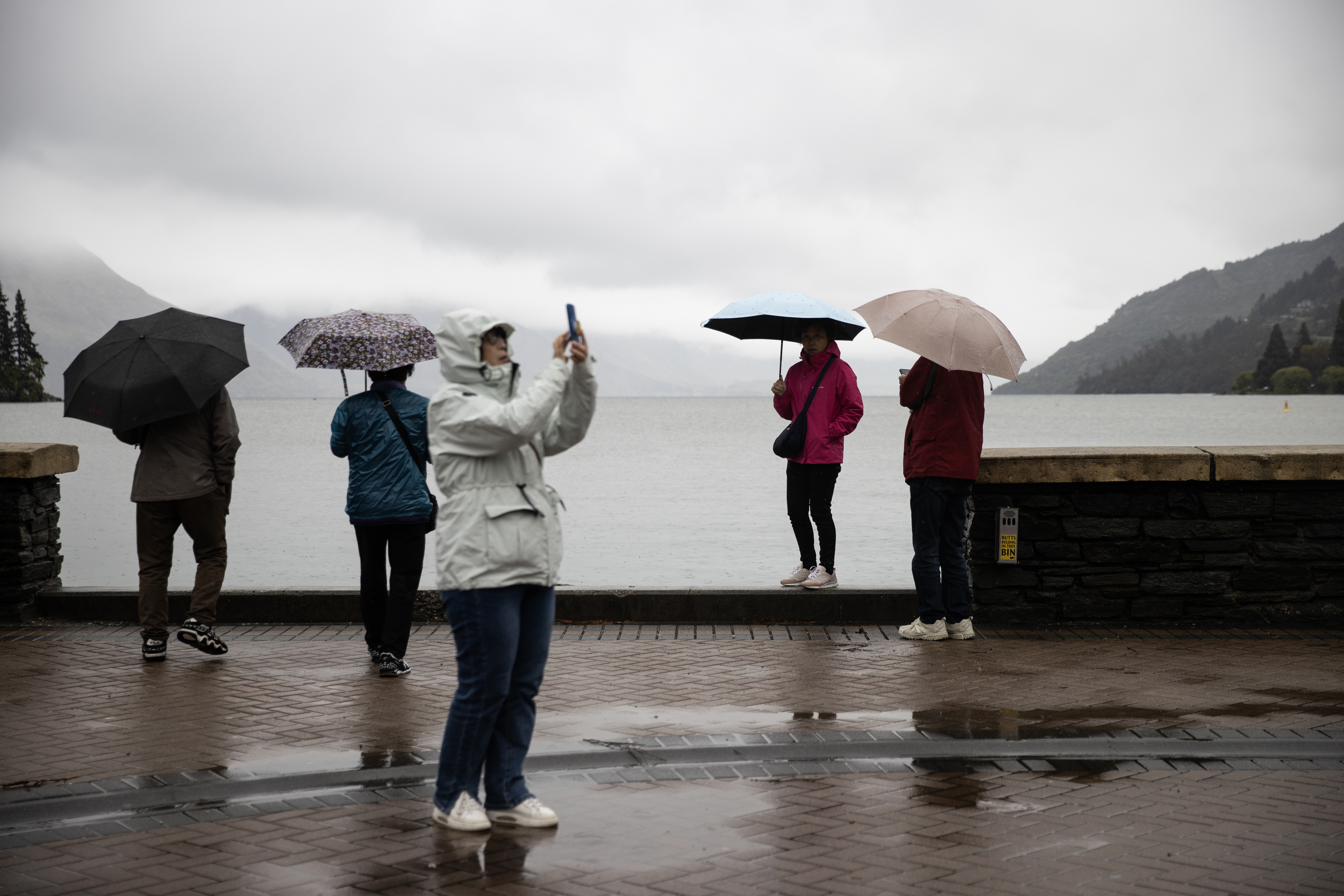 The rain hasn't kept the tourists away in Queenstown. Photo / George Heard