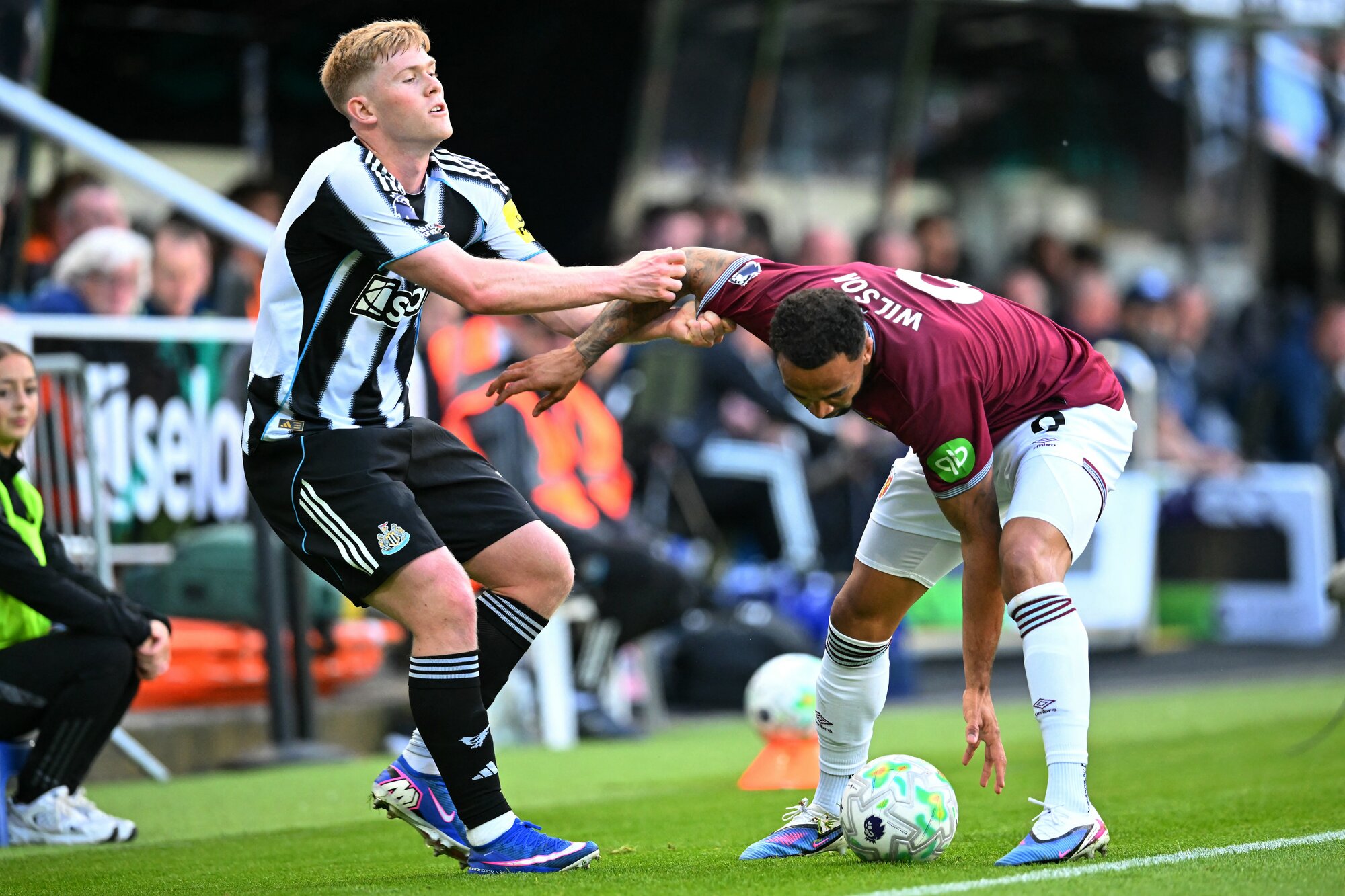 Newcastle United midfielder Lewis Hall tangles with West Ham United striker Callum Wilson at St James' Park. Photo / Andy Buchanan, AFP
