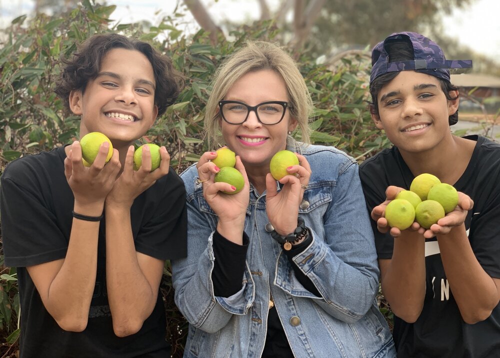 Joh Leader with two of her LeaderLife kids, working to grow and harvest limes. Photo / LeaderLife