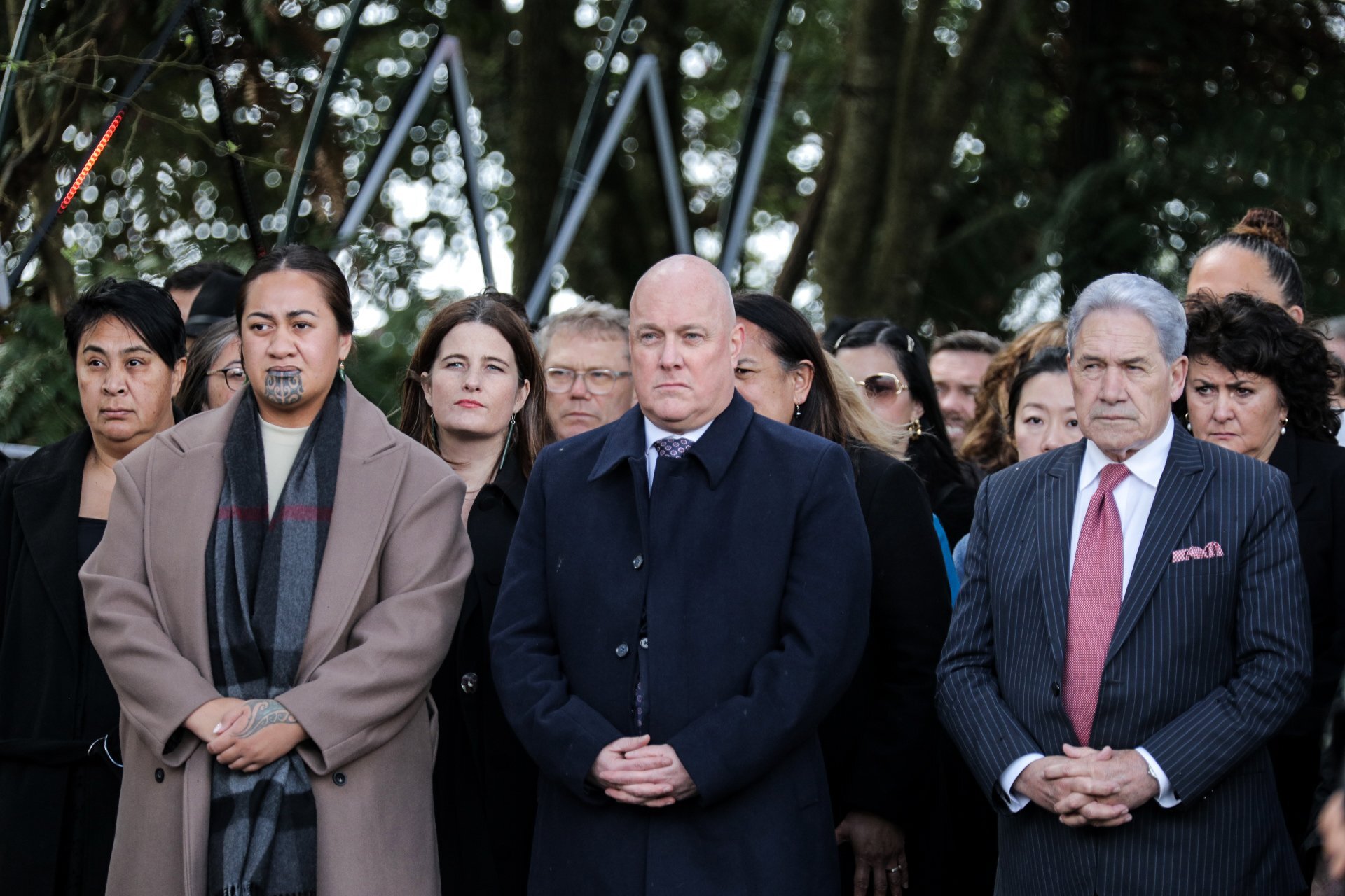 Prime Minister Christopher Luxon (centre) and New Zealand First leader Winston Peters (right) at Tūrangawaewae Marae for Koroneihana 2024 celebrations for the coronation of Kiingi Tuheitia. Photo / Nick Monro, RNZ