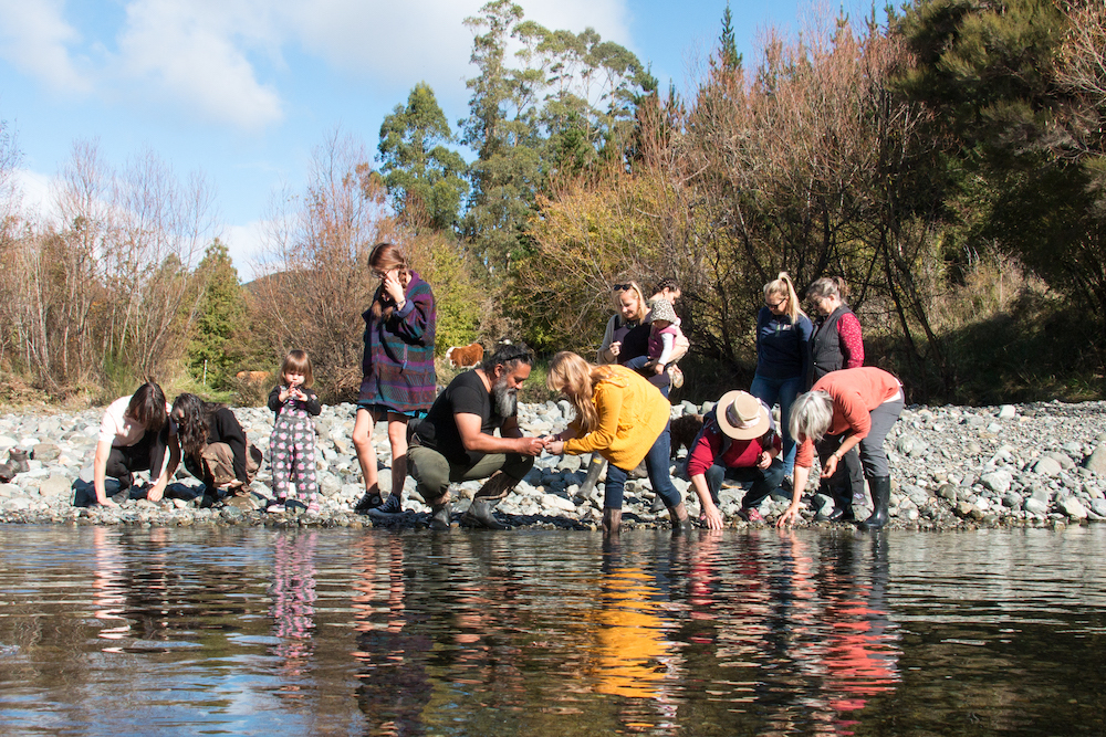 Timoti Moran, owner-operator of Nelson-based tourism experience Taonga by Timoti (centre, kneeling) with guests. Photo / Supplied