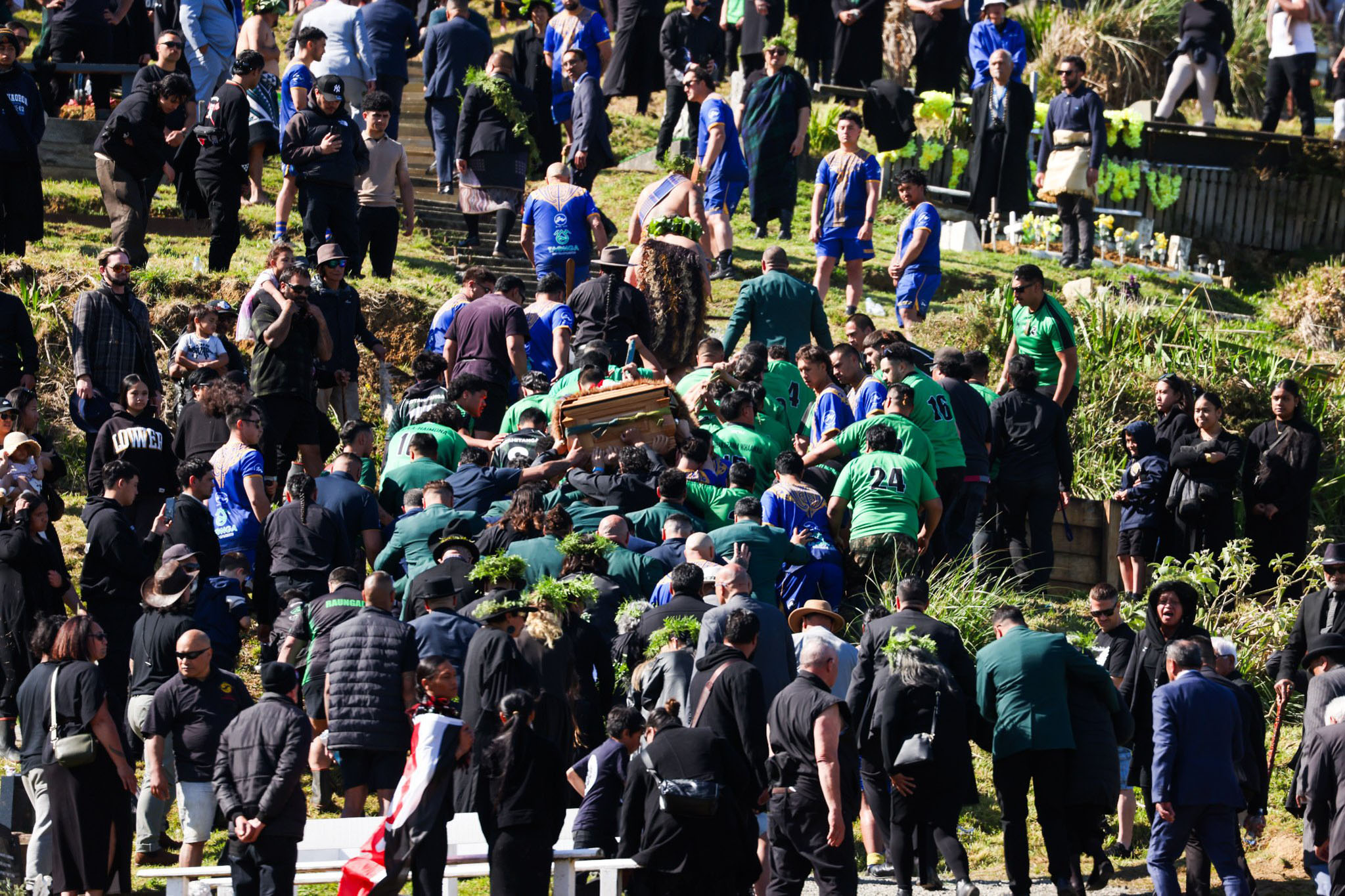 The late King’s casket is being carried onto Taupiri - where more mourners begin to chant and cry. Hundreds of people standing on the maunga dressed in black are performing a haka - Te Waka then Ka Mate.
Photo / Mike Scott