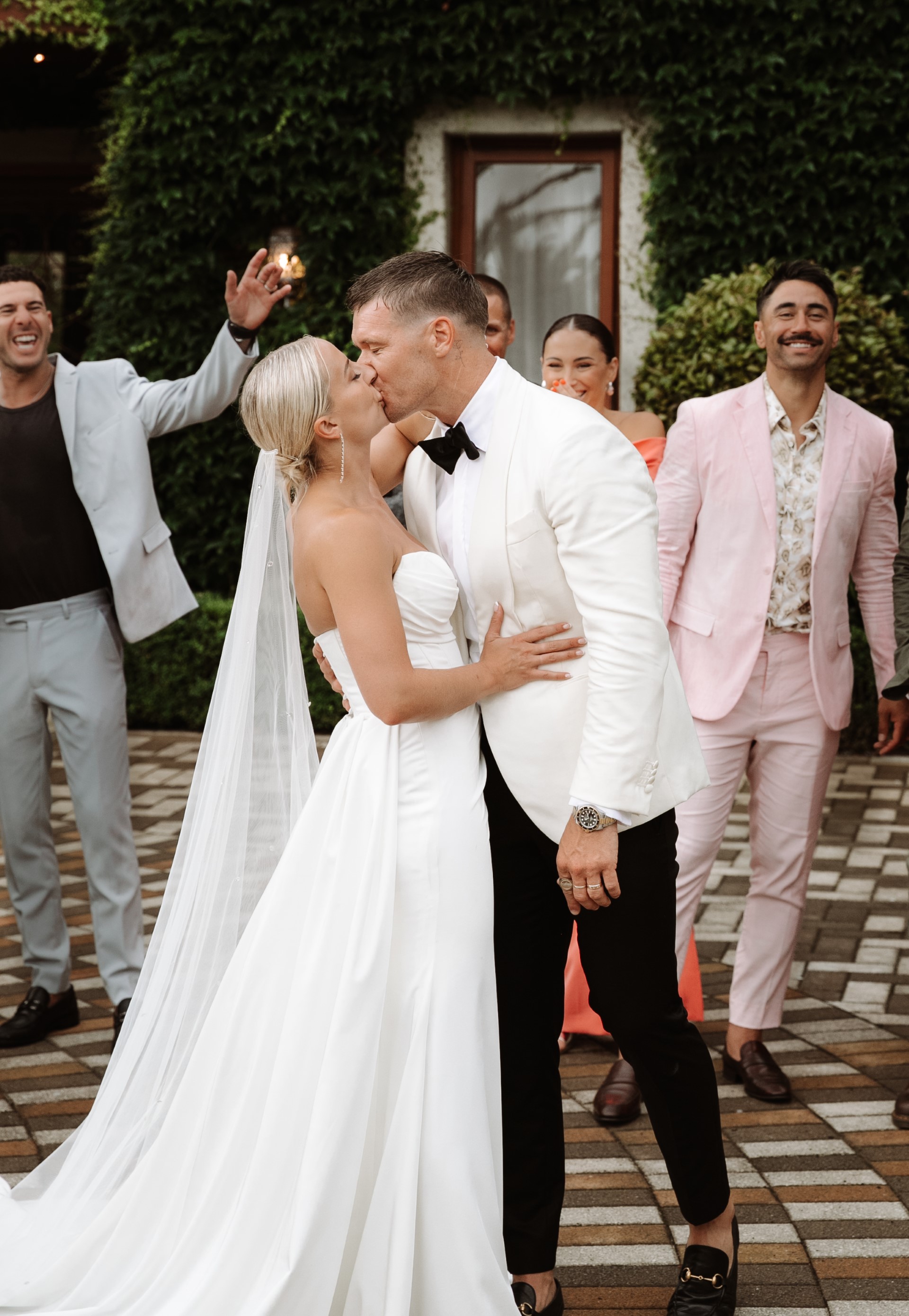 Robinson wore a white strapless Jane Hill gown while Dodds wore a cream tuxedo by Crane Brothers. Photo / Jonny Scott