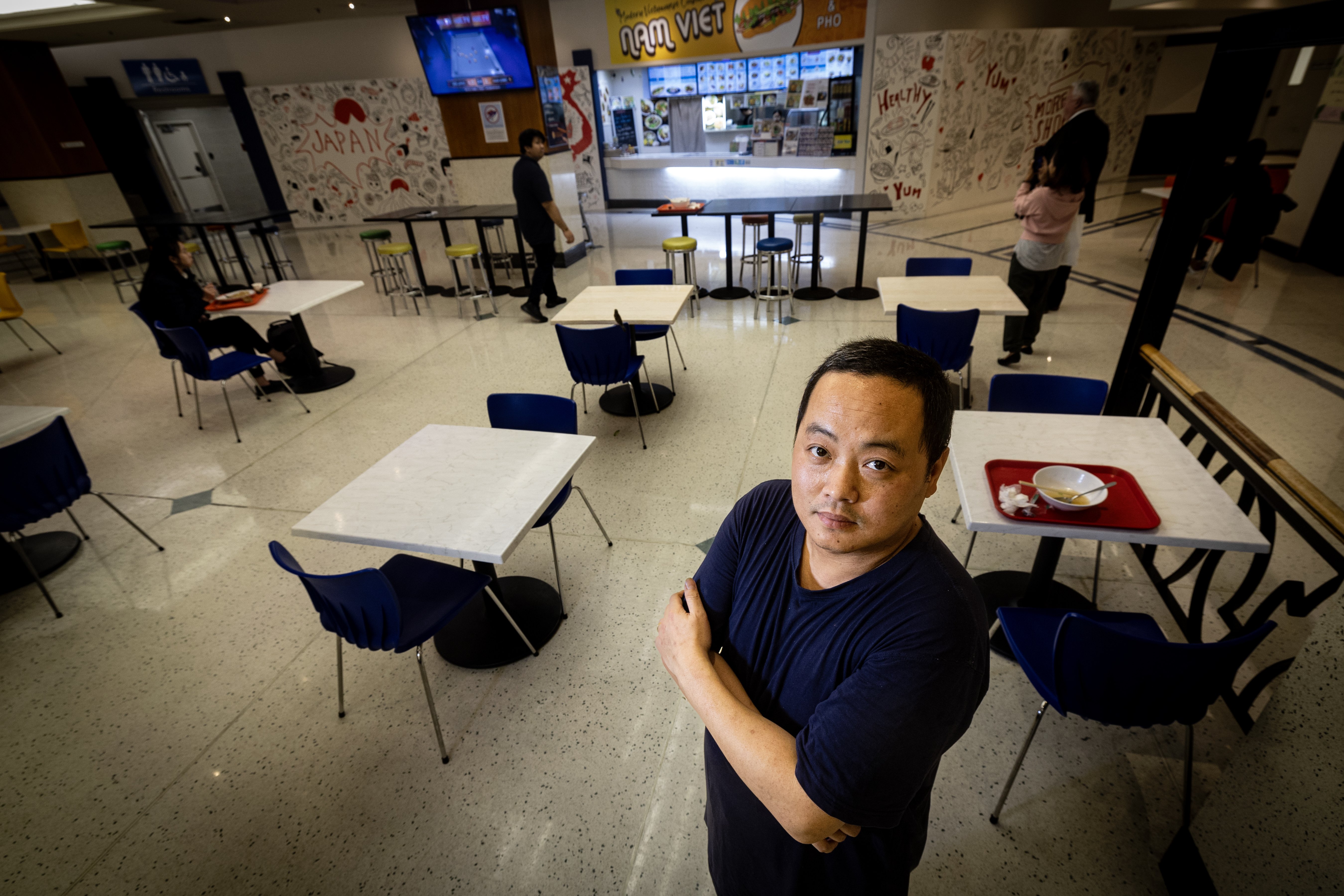 Nam Viet owner Khuong Duc An Huynh amongst the empty tables at the food court at Atrium on Elliott. His customers tell him they don't feel safe coming to the central city. Photo / Jason Oxenham 