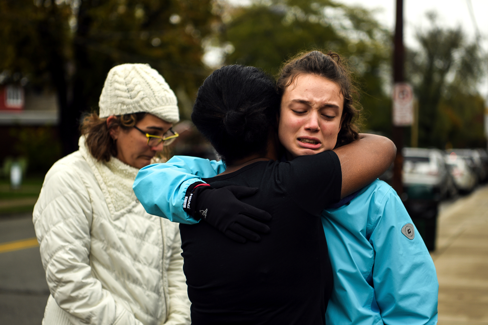 People hug outside the Tree of Life Congregation after multiple people were shot. Photo / AP