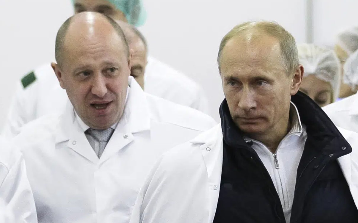 Yevgeny Prigozhin shows Vladimir Putin around his factory which produces school meals, outside St Petersburg. Photo / AP, File