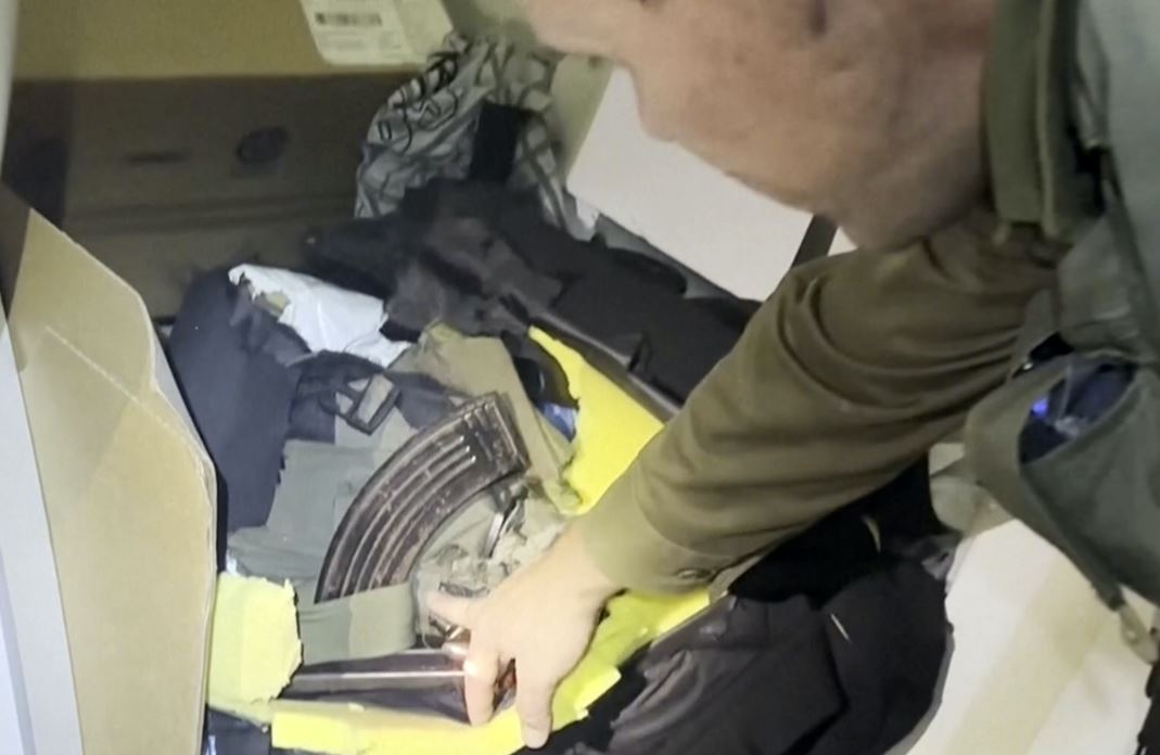 An image released by the Israel Defence Forces of Lt Col Jonathan Conricus, an Israeli military spokesman, pointing to a weapons cache the IDF says was found in an MRI centre at Shifa Hospital in Gaza City. Photo / AP