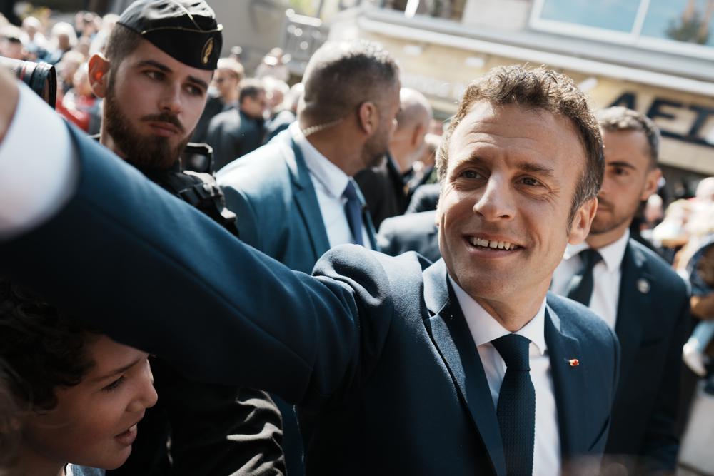 French President and centrist candidate Emmanuel Macron shakes hands with well-wishers as he heads to the polling station in Le Touquet, northern France. Photo / AP