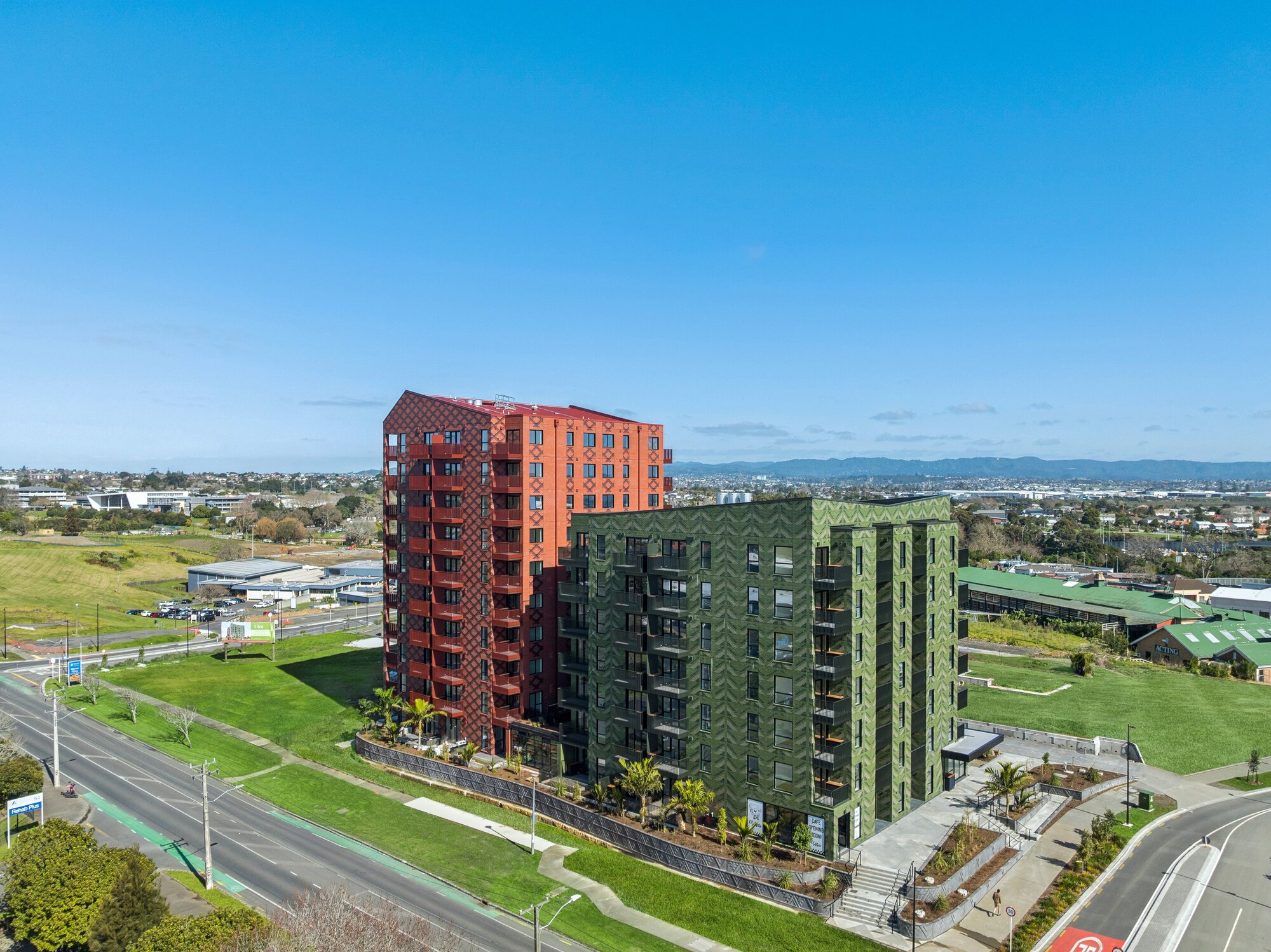  Ockham Residential and five-iwi collective Marutūāhu collective have developed the red Whetū apartment block and the green Toi at Pt Chevalier in Auckland. This is on former Unitec land. Photo / Ockham