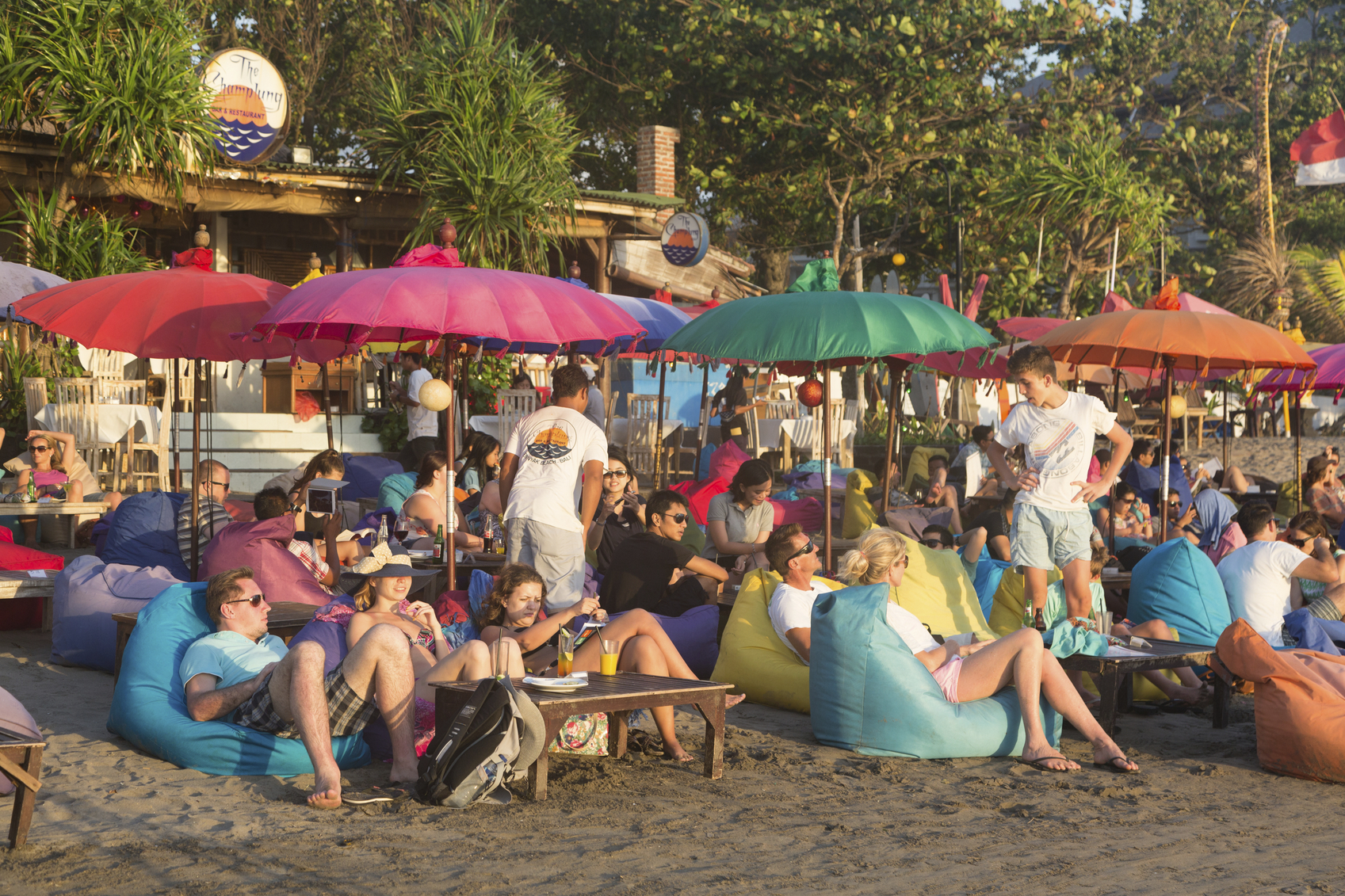 Tourists enjoy a drink in a beach bar along Seminyak beach, just north of Kuta, in Bali, in this 2014 photo. 
