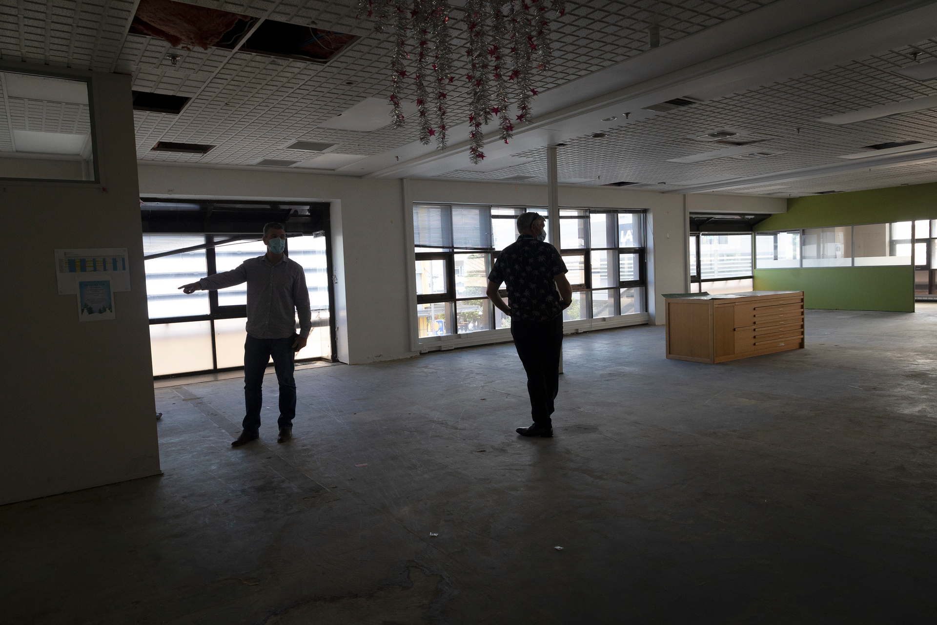 Tauranga City Council chief executive Marty Grenfell points to an area of mould while senior projects manager Richard Conning looks on. Photo / Andrew Warner