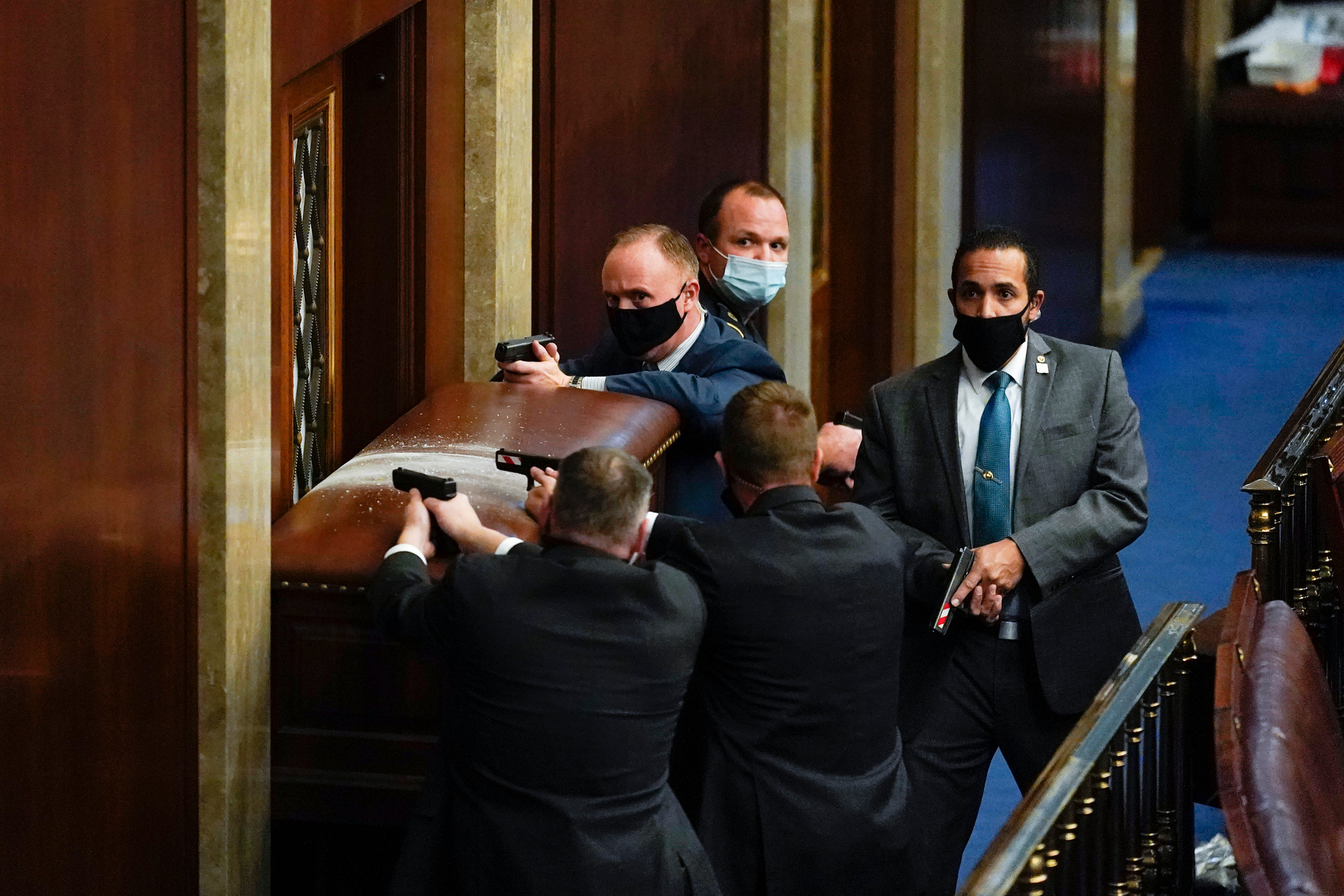 US Capitol Police with guns drawn stand near a barricaded door as protesters try to break into the House Chamber on January 6. Photo/Andrew Harnick, AP, File
