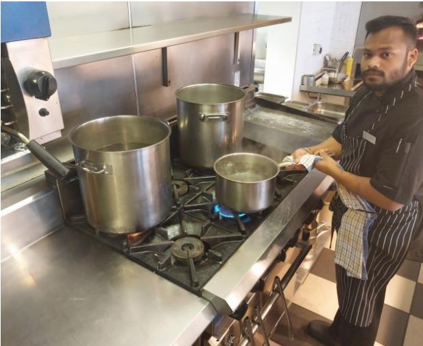 Chef Kshitij Zungare tends to pots of water being boiled for guests and staff of Hotel St Moritz, in Queenstown in September. Photo / Matt Porter
