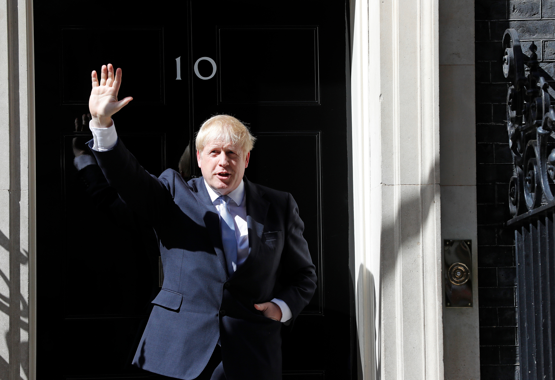 Britain's new Prime Minister Boris Johnson waves from the steps outside 10 Downing Street, London. Photo / AP