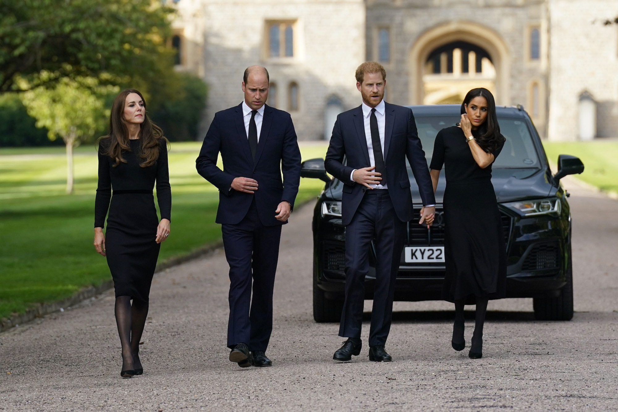 Kate, the Princess of Wales, Prince William, Prince of Wales, Prince Harry and Meghan, Duchess of Sussex walk to meet members of the public at Windsor Castle, after the death of the Queen in September, a rare public appearance of solidarity for the former 