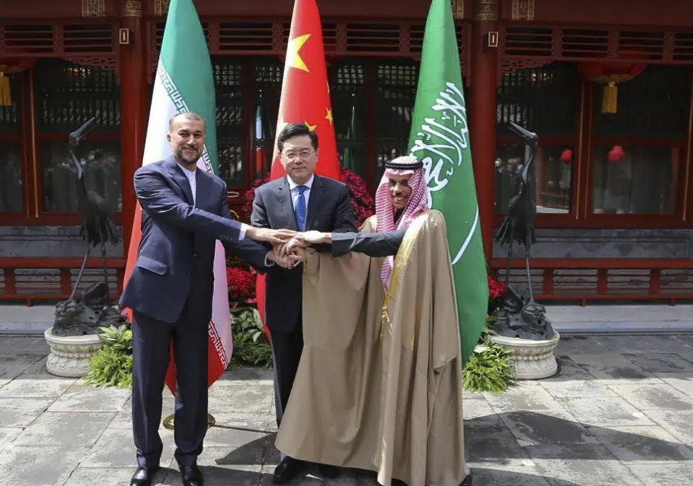 Iran's foreign minister shakes hands with his Saudi Arabian and Chinese counterparts. Photo /  Iranian Foreign Ministry