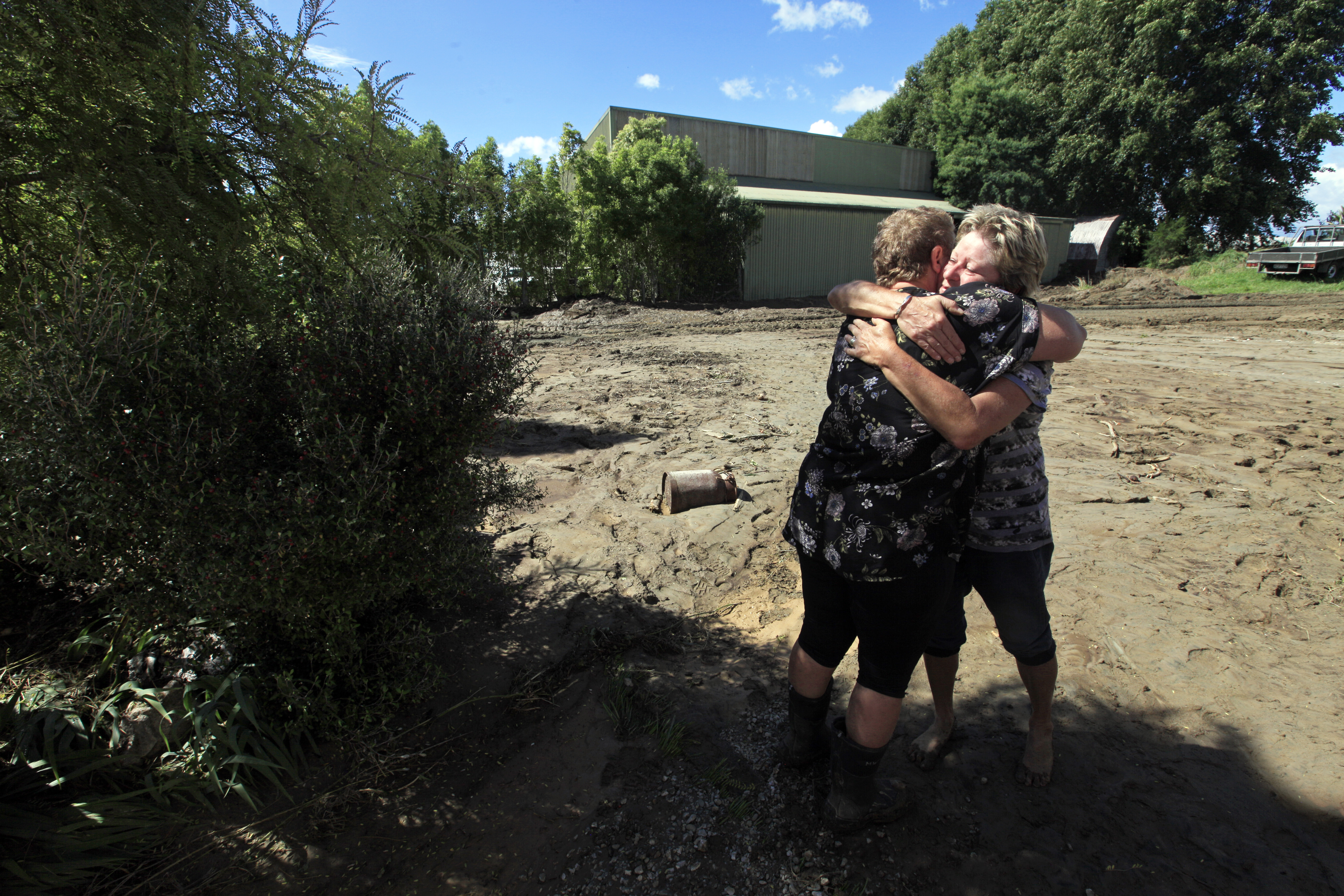 Ex-Cyclone Gita damage in Riwaka, Nelson, New Zealand: A hug for Val A'Court from friend Monika Walter as Val starts the clean-up of her silt-covered property. Photo / Tim Cuff