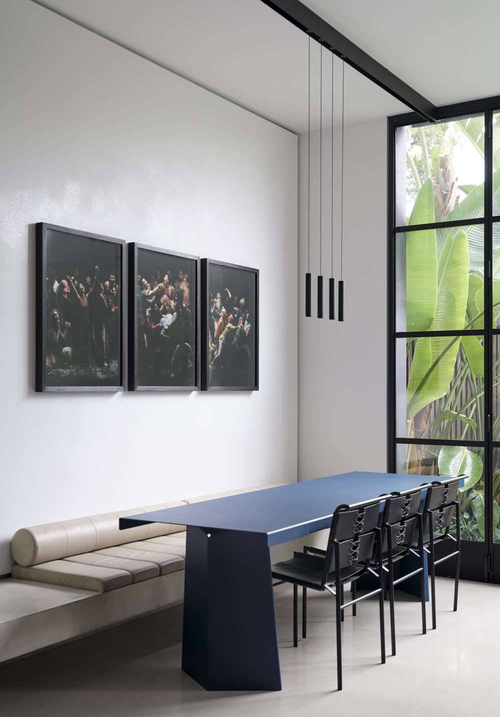 A triptych photograph by Angela Tiatia adorns her dining room.
