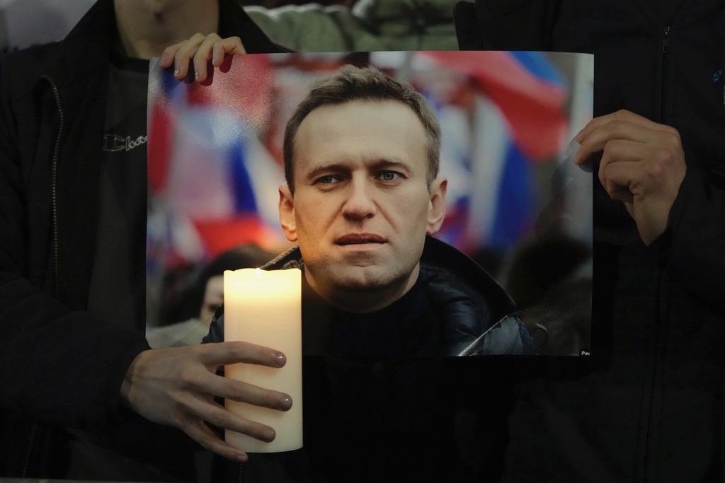 Protesters hold a picture of Alexei Navalny as they stage a demonstration outside the Russian Embassy in London. Photo / AP