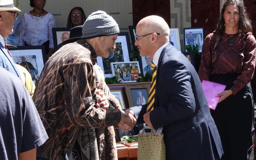 Te Ihutai kaumātua Pai Tahere accepts a copy of the Waitangi Tribunal report, on behalf of Hokianga claimants, from presiding officer. Photo / Craig Coxhead.