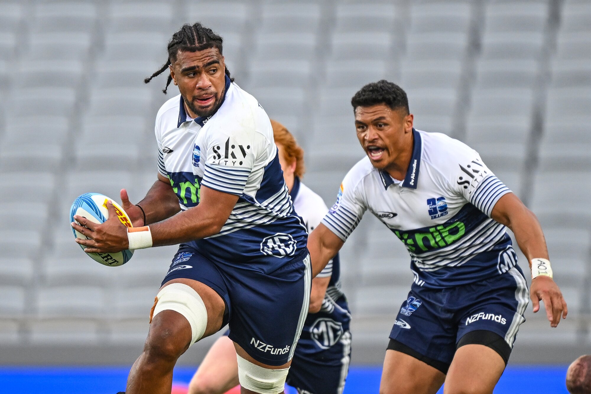 Hoskins Sotutu on the charge for the Blues, with Caleb Clarke in support. Photo / Photosport