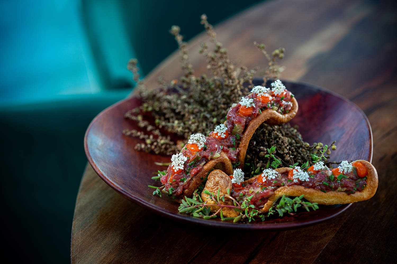 Tahr tartare atop compressed Yorkshire pudding with wild garlic. Photo / Babiche Martens