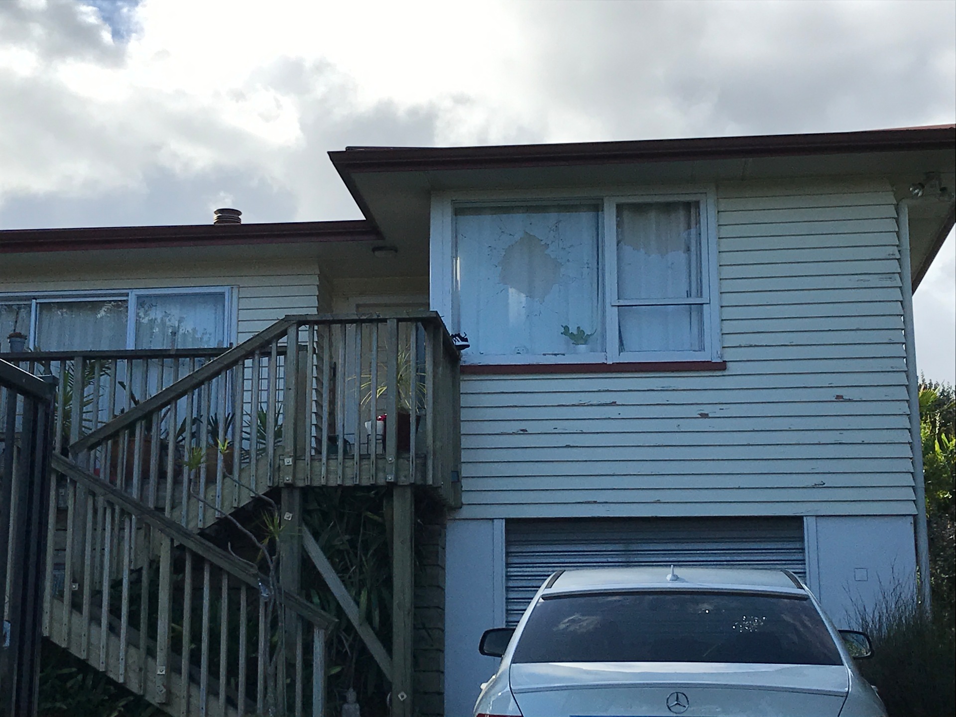 A shot out window at a house in Te Atatu South where one of the shootings occurred overnight. Photo / Tom Dillane