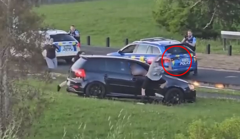 Footage has emerged of the dramatic arrest of an armed man driving erratically in Glen Innes, which left one person in a serious condition. The video shows a black car driving on the grass in a reserve near Leybourne Circle. Photo / via video
