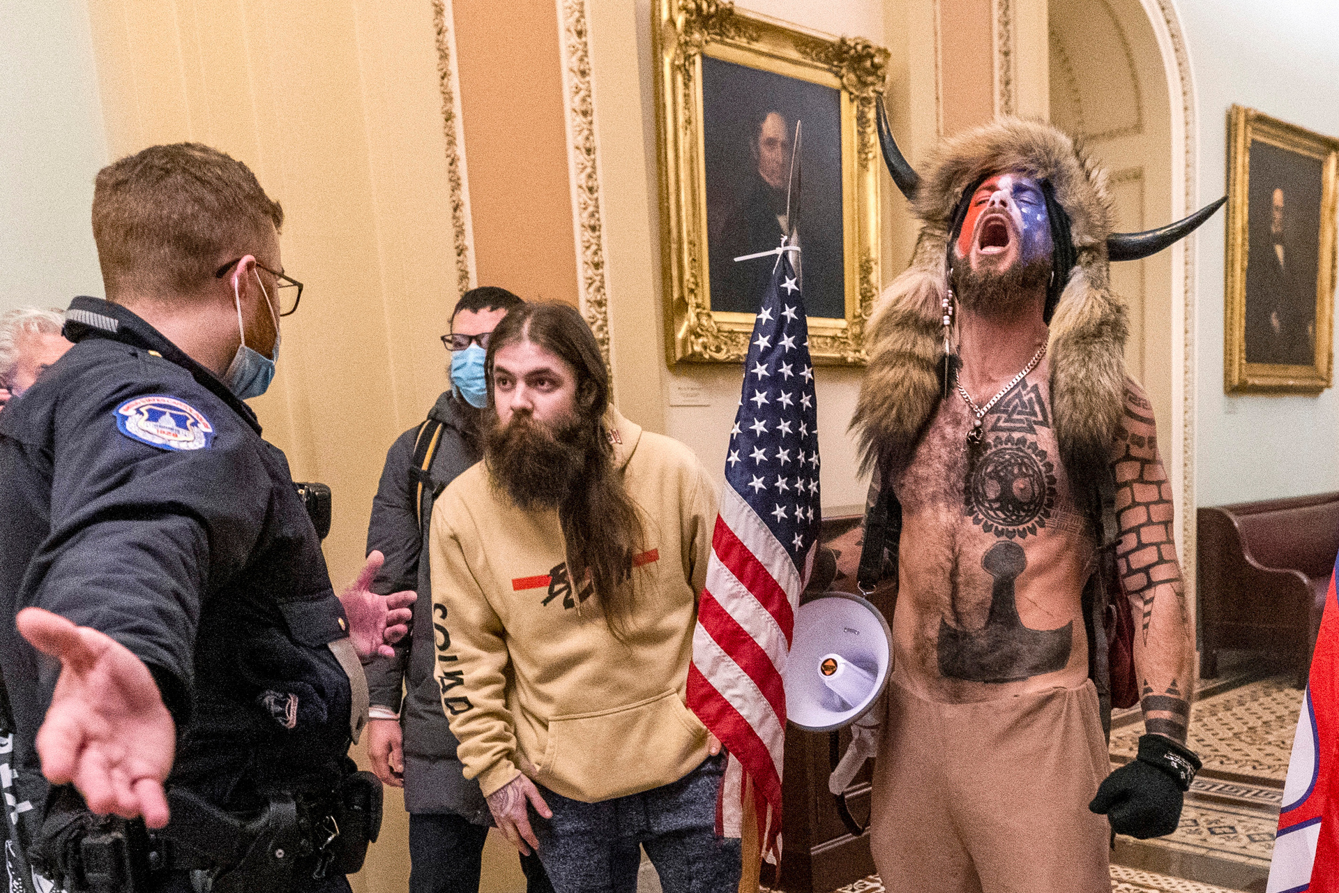 Supporters of President Donald Trump confronted by US Capitol Police officers outside the Senate Chamber. Photo / AP