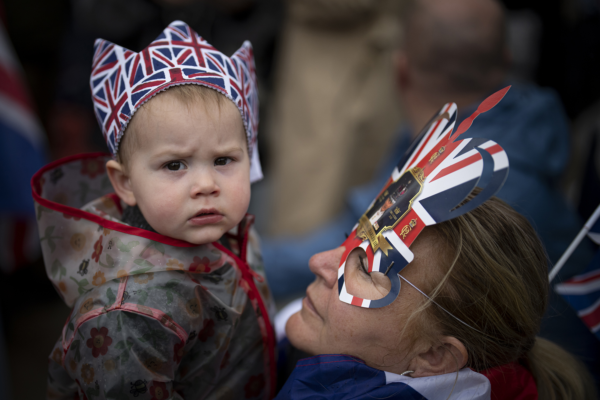 A woman holds a little boy wearing a crown before the start of Britain's King Charles III coronation ceremony on The Mall. Photo / AP