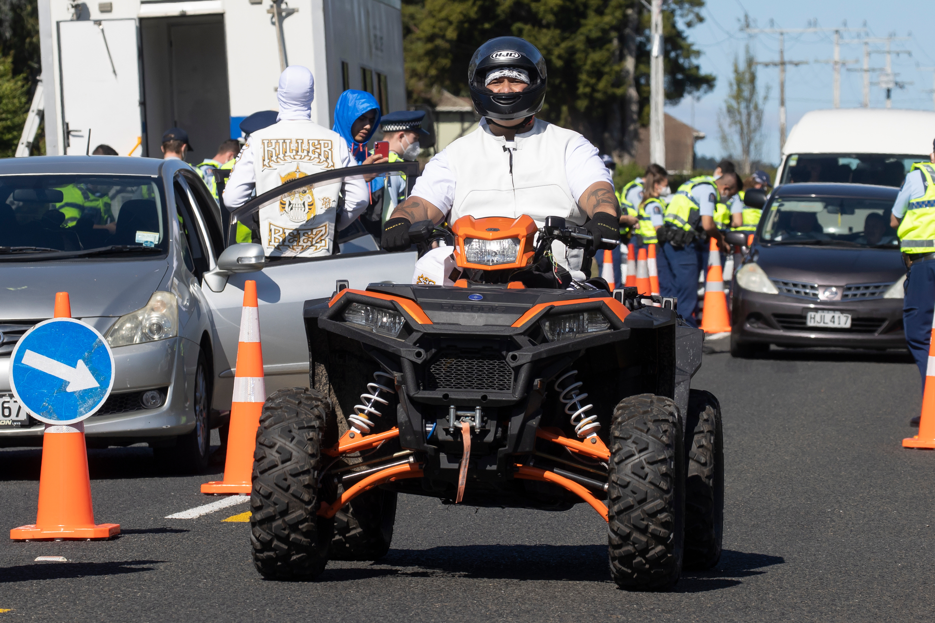 Killer Beez president Josh Marters, now paralyzed after he was shot in 2019, rides a quad bike during a police check point targeting the gang's AGM in April 2022. Photo / Brett Phibbs