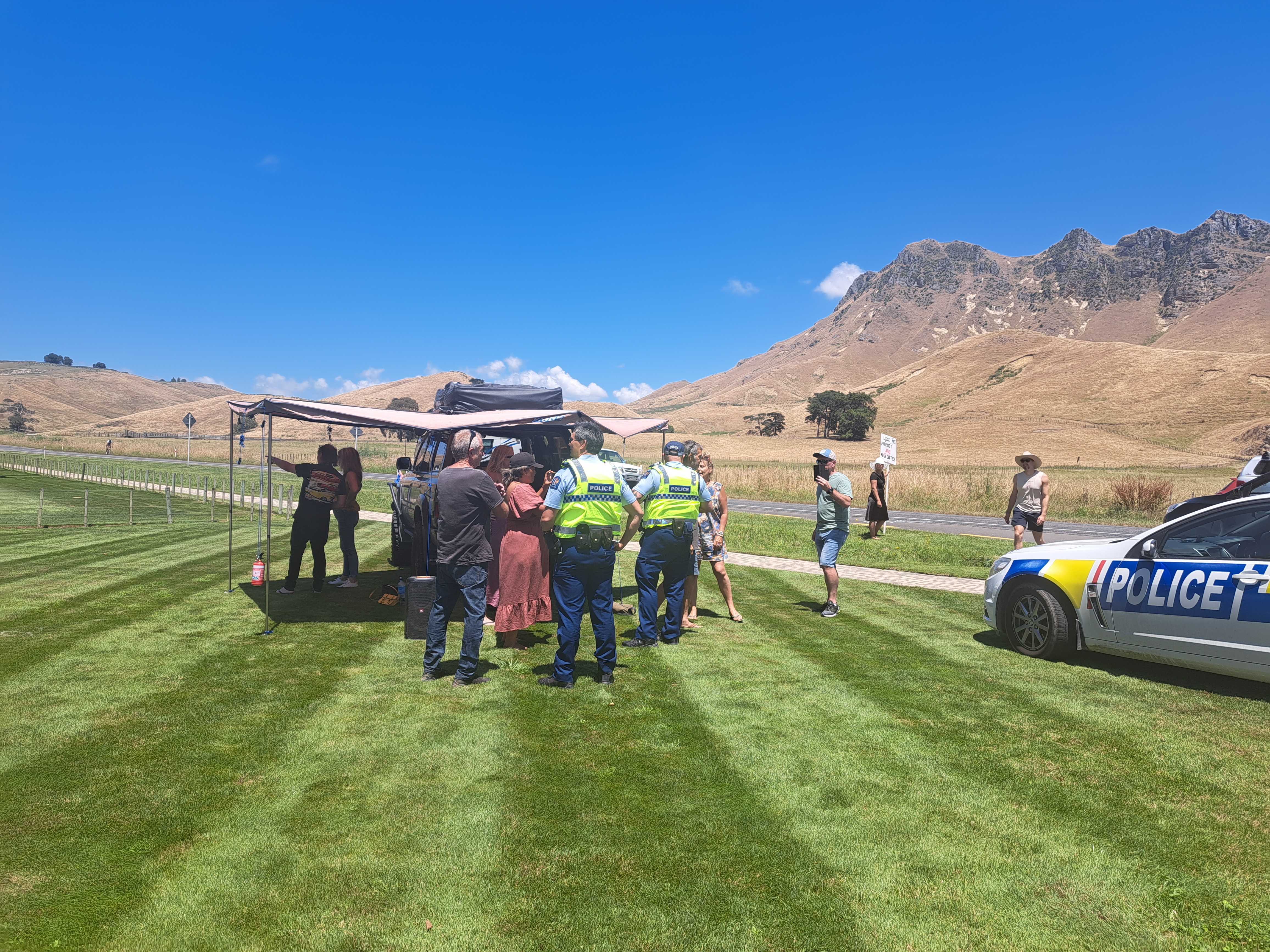 Police talk to protesters outside the Hawke's Bay venue. Photo / Neil Reid