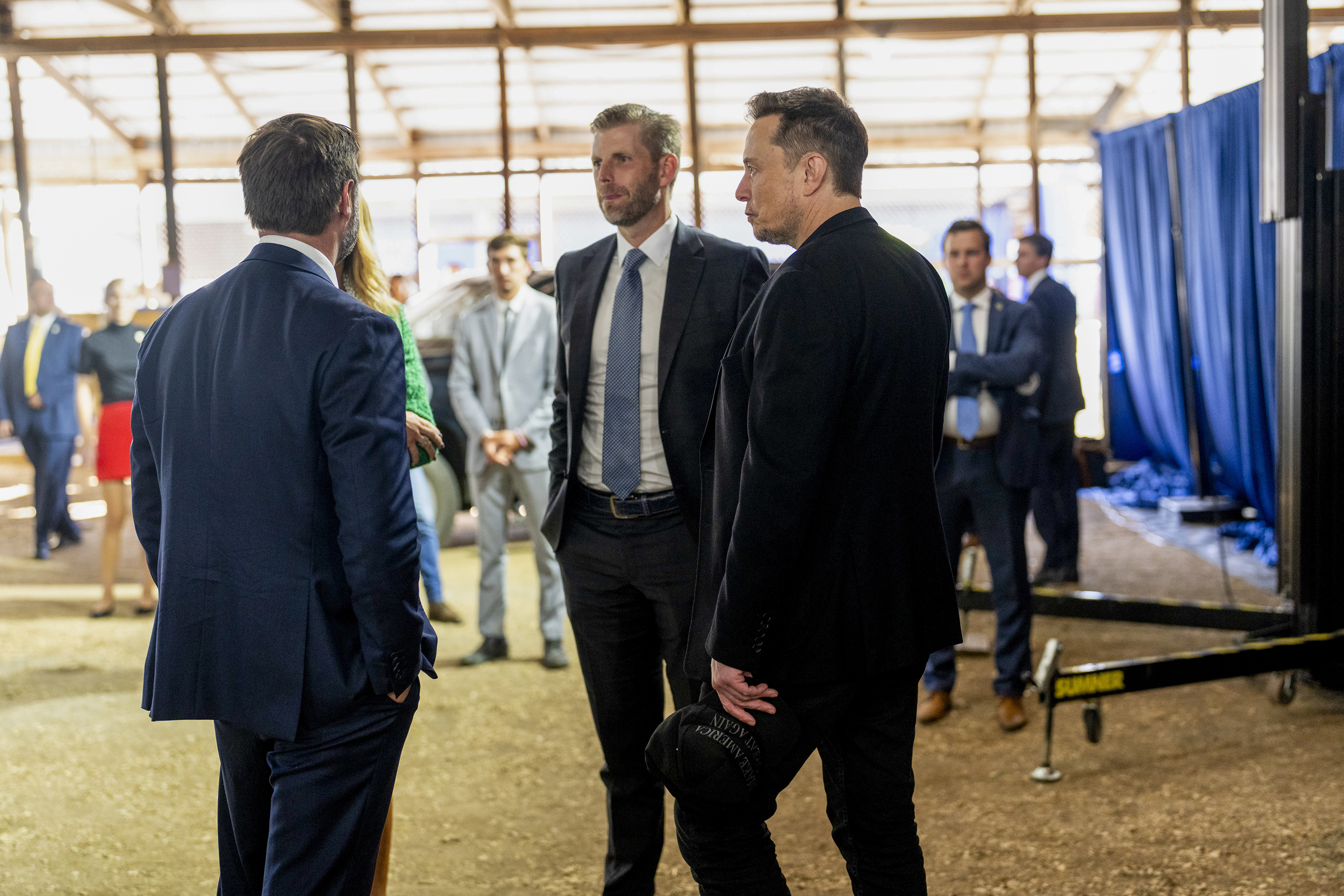 Musk, right, backstage with Eric Trump, centre, and Senator JD Vance during Trump’s rally in Butler. Photo / Doug Mills, The New York Times