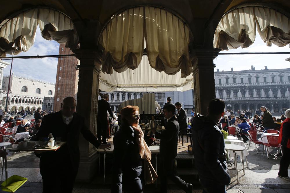 Tourists who crowd Venice's St. Mark's Square in will now be obliged to make reservations and pay a fee to visit the historic lagoon city. Photo / Luca Bruno, AP