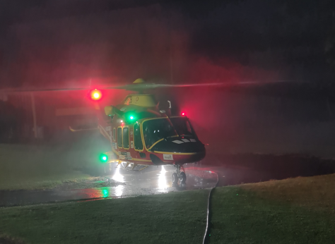 A Westpac rescue helicopter refuels in the rain during the search and rescue efforts last night. Photo / Auckland Rescue Helicopter Trust