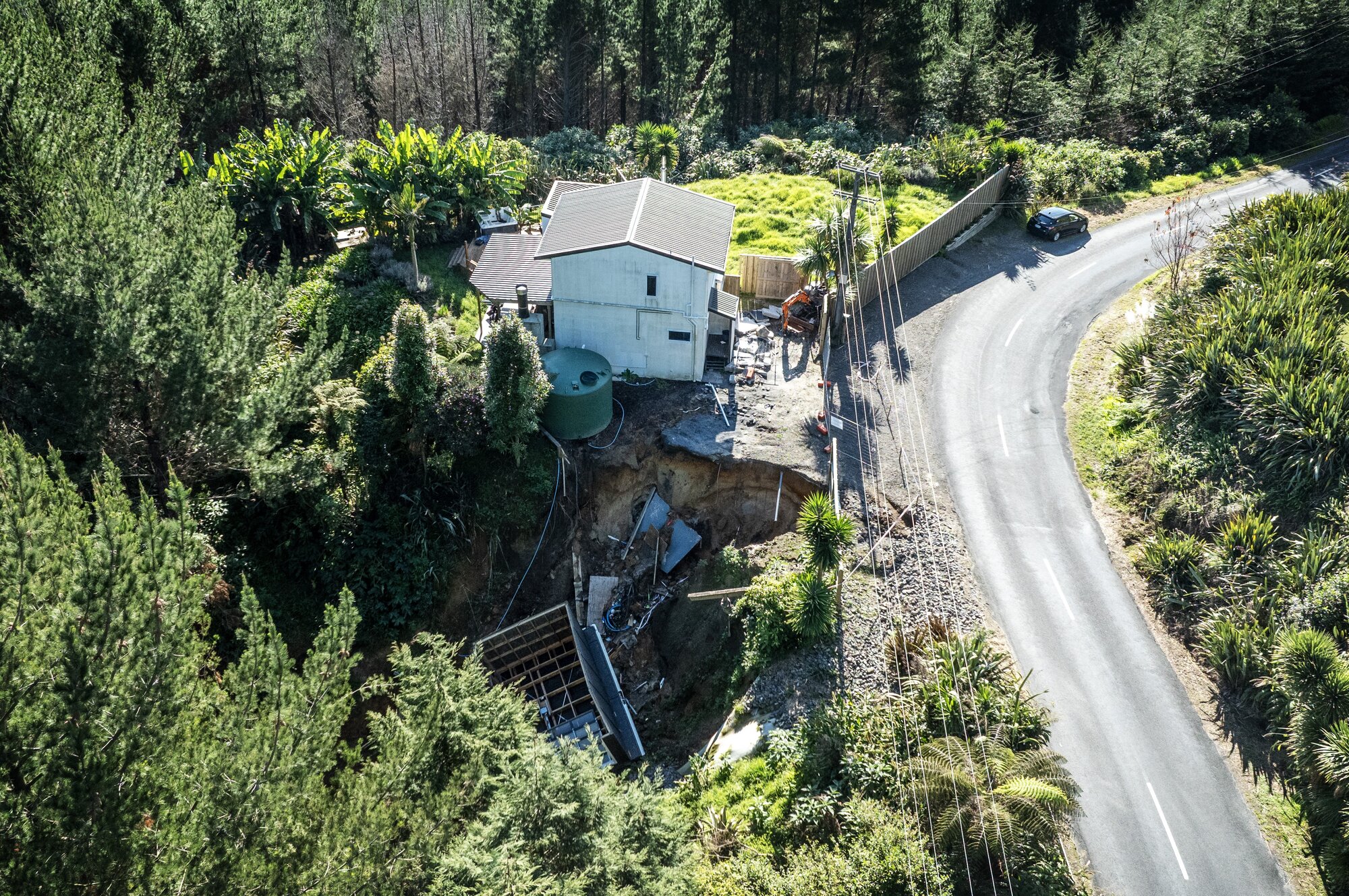 The home of Sian and Matt du Plessis sits near the edge of a large slip, red-stickered, unoccupied and so far undamaged. Photo Mike Scott