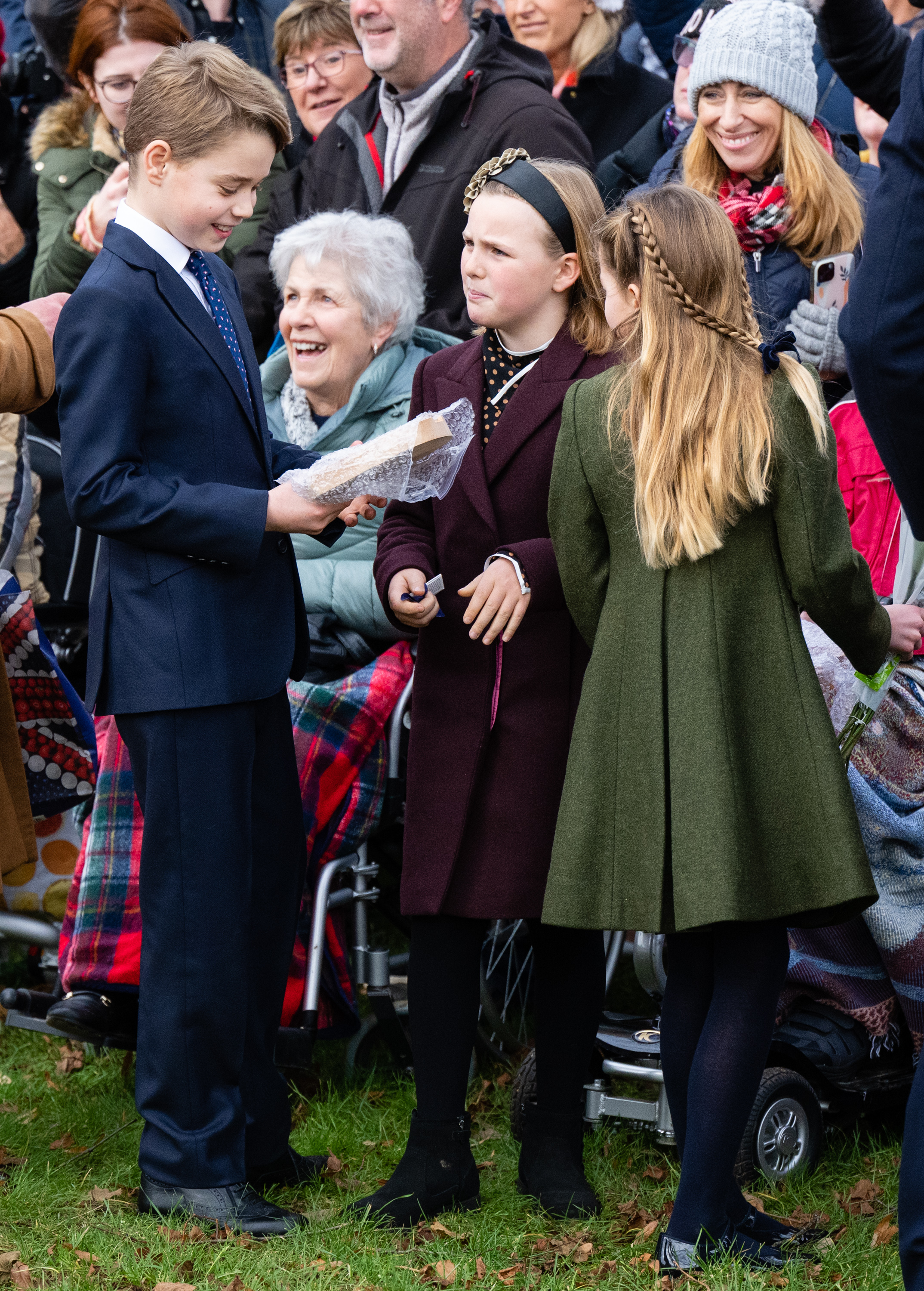 Prince George was joined by Mia and his sister, Princess Charlotte, as he looked at a gift from a member of the crowd. Photo / Getty Images