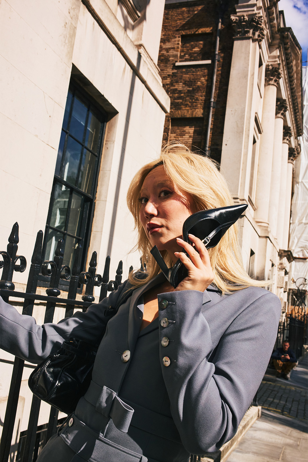 A heel held like a phone on the streets between shoes for London Fashion Week. Photo / Simbarashe Cha for The New York Times